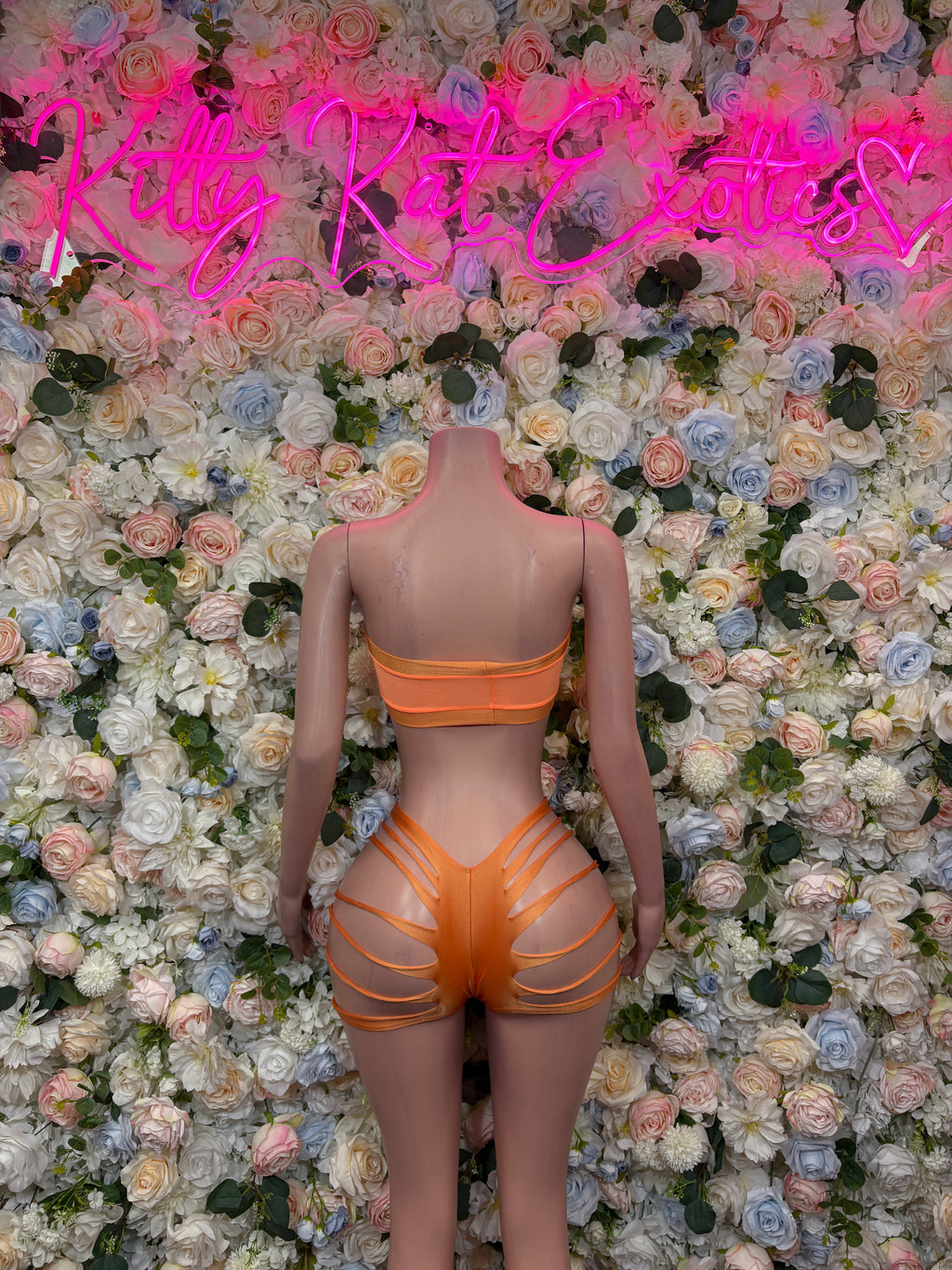 Orange two-piece dancewear set with bandeau back and strappy cutout shorts