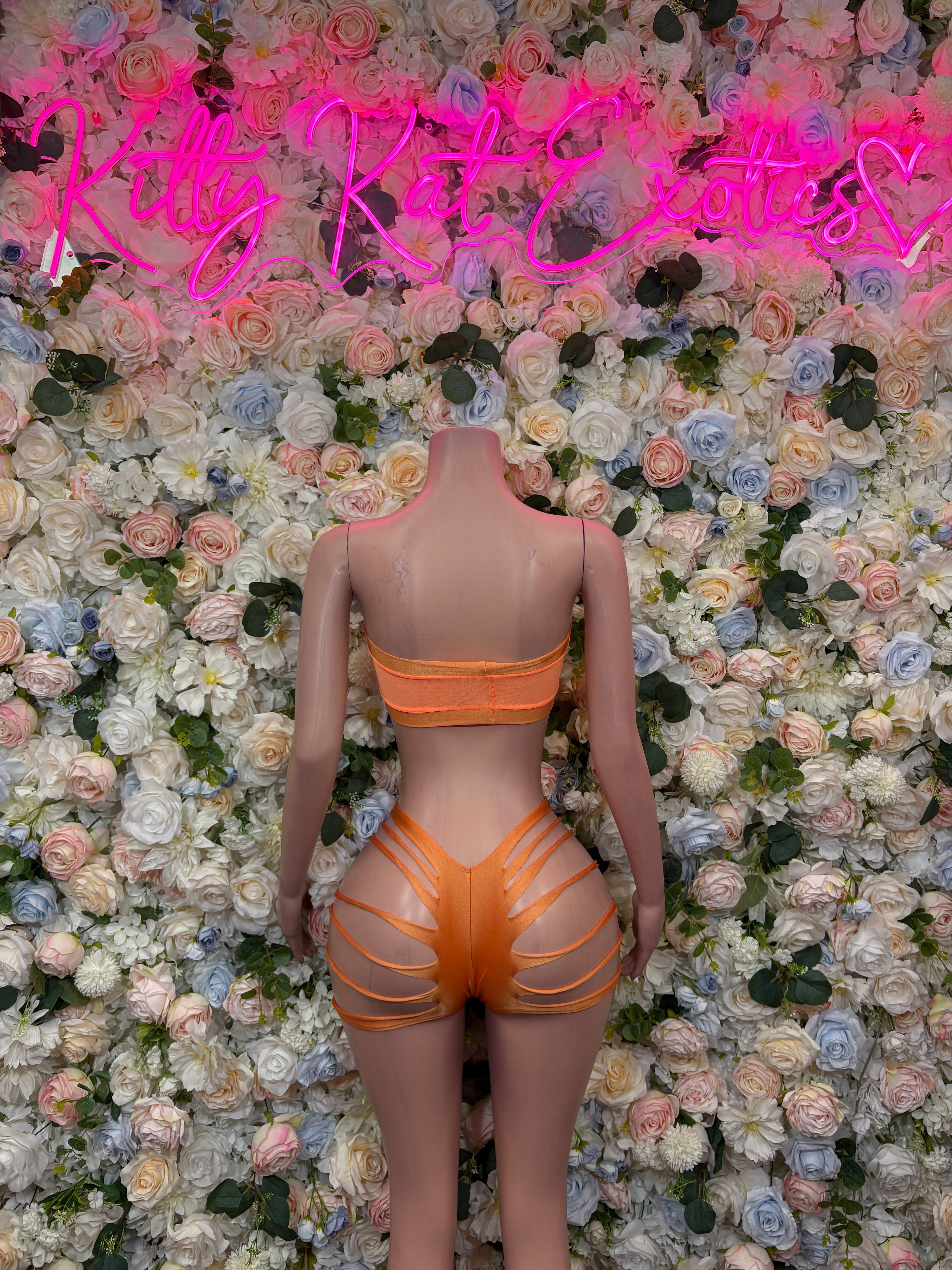 Orange two-piece dancewear set with bandeau back and strappy cutout shorts