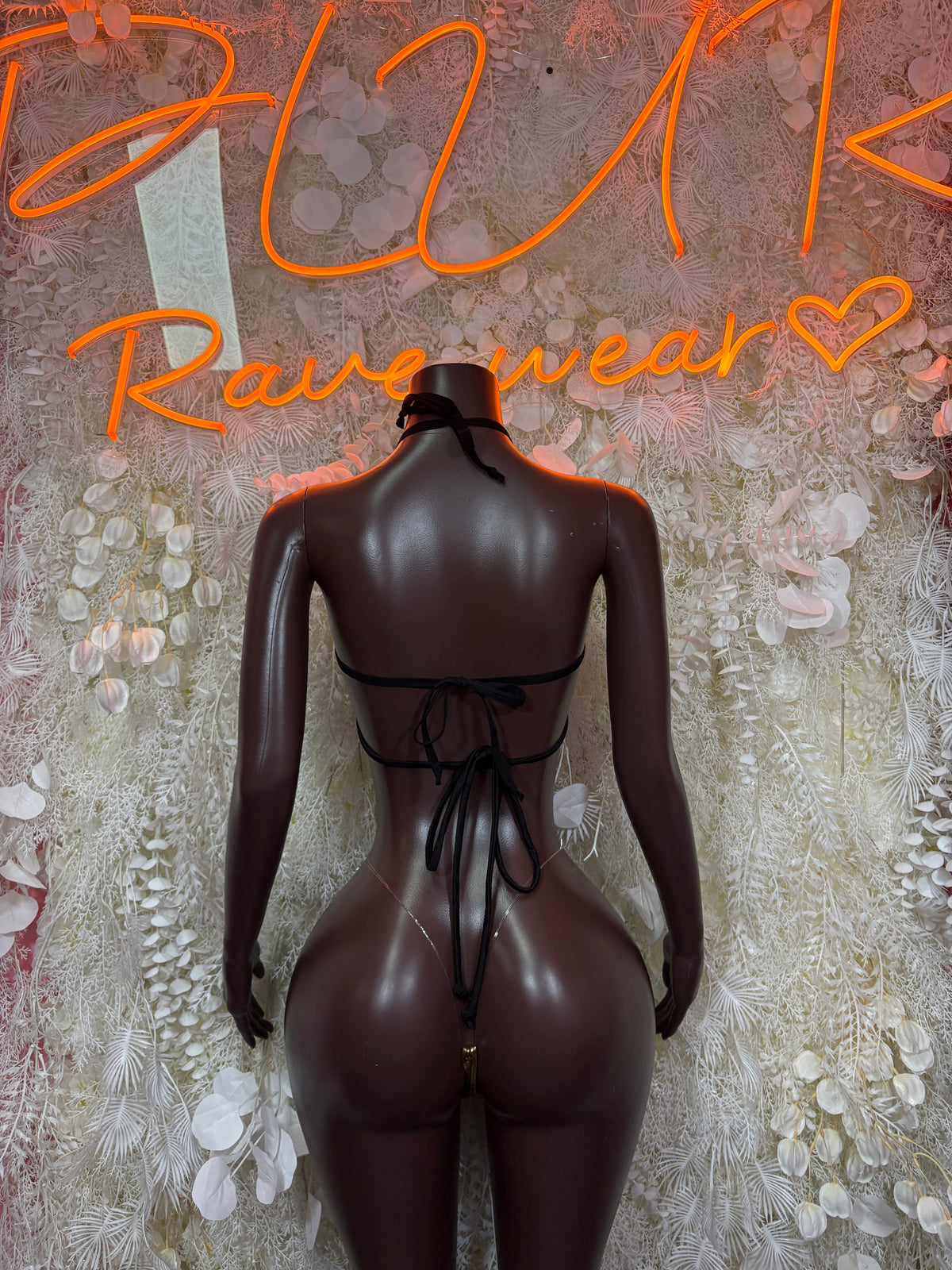Black lace-up cutout bodysuit with open back and tied bow at lower back