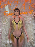 Gold fringe bikini set with black trim, V-neck top, and matching gold tassel bottom