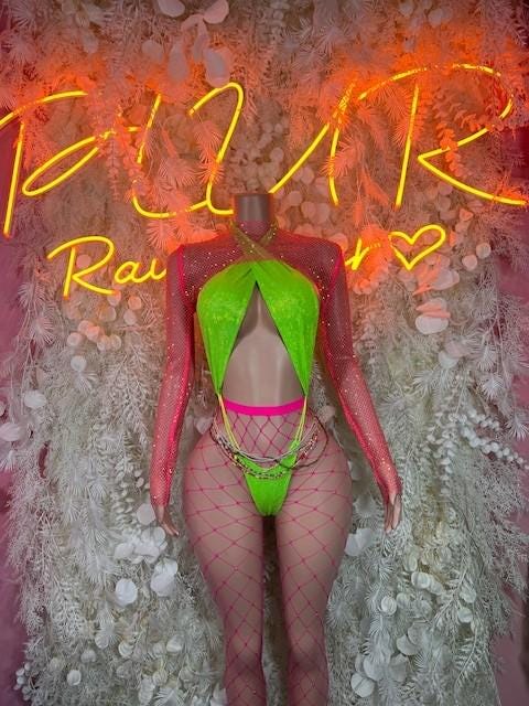 Green one-piece rave bodysuit with mesh fishnet legs, cutout bust, pink straps