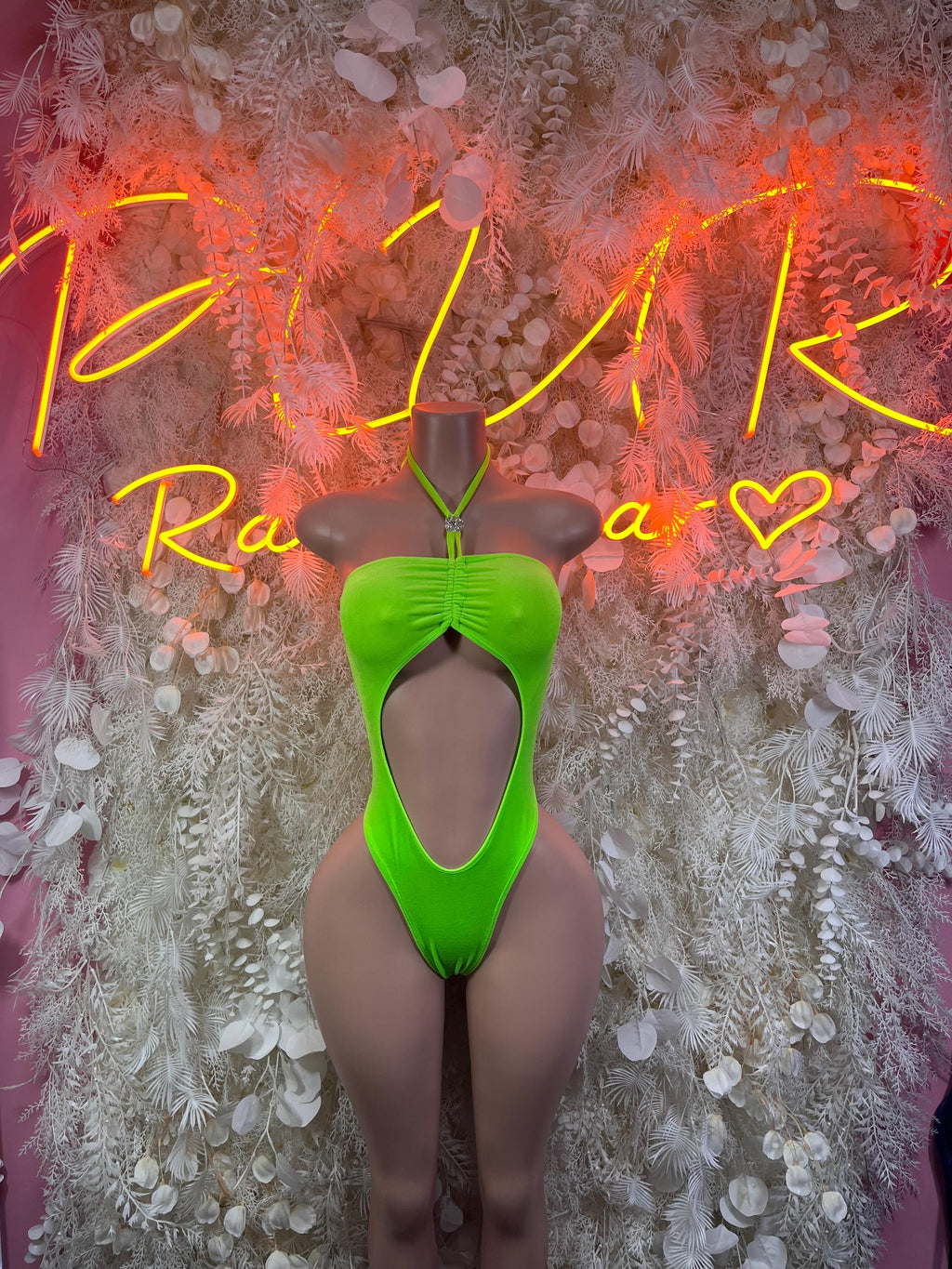 Neon green one-piece bodysuit with wide cutout front and halter neck strap