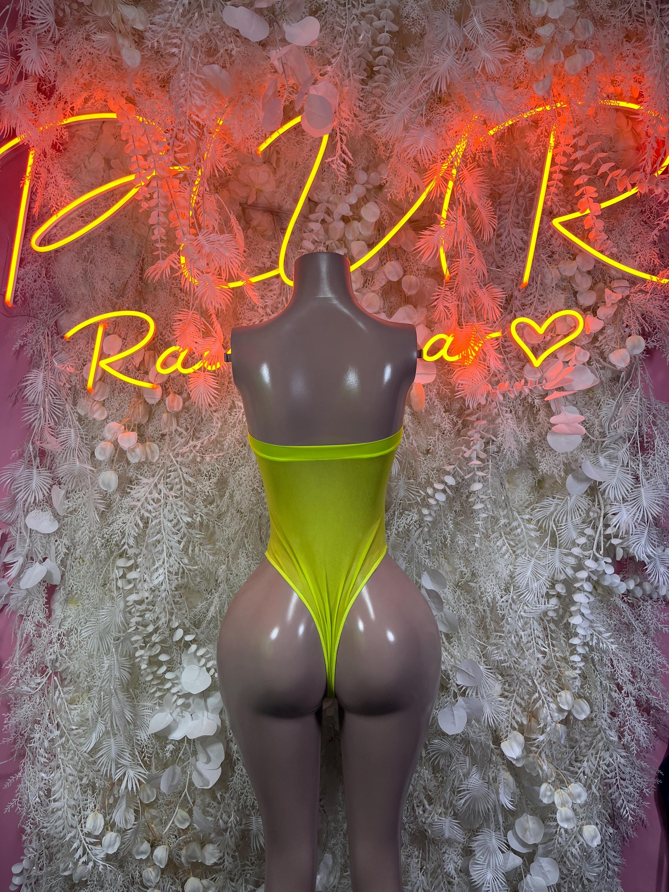 Neon green sleeveless one-piece bodysuit with V front and high-cut leg openings.