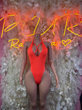 Neon orange one-piece bodysuit with front cutout and thin crossover straps