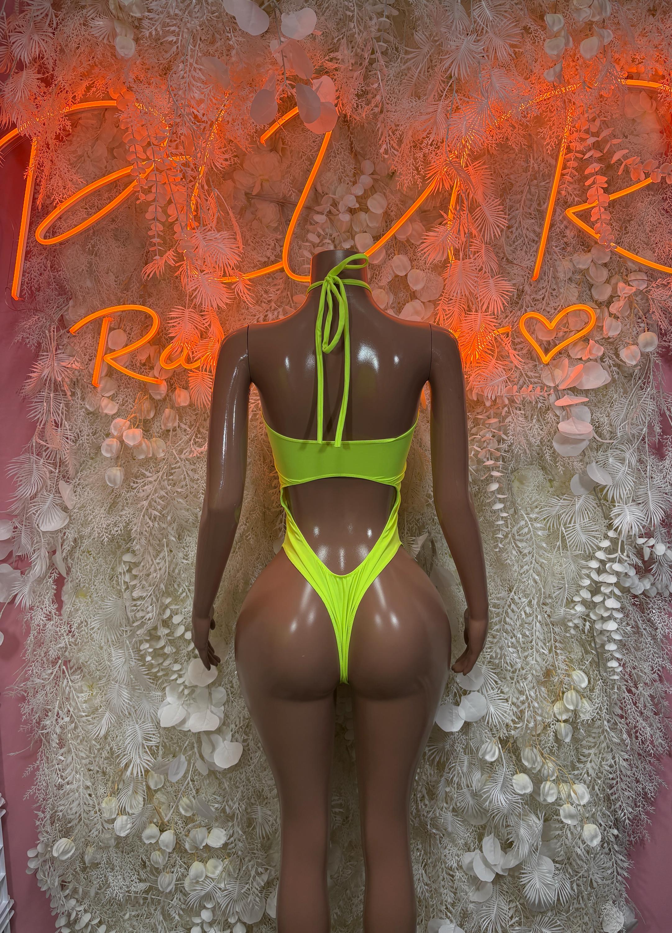 Neon green one-piece rave bodysuit with open back and V-shaped cutout straps