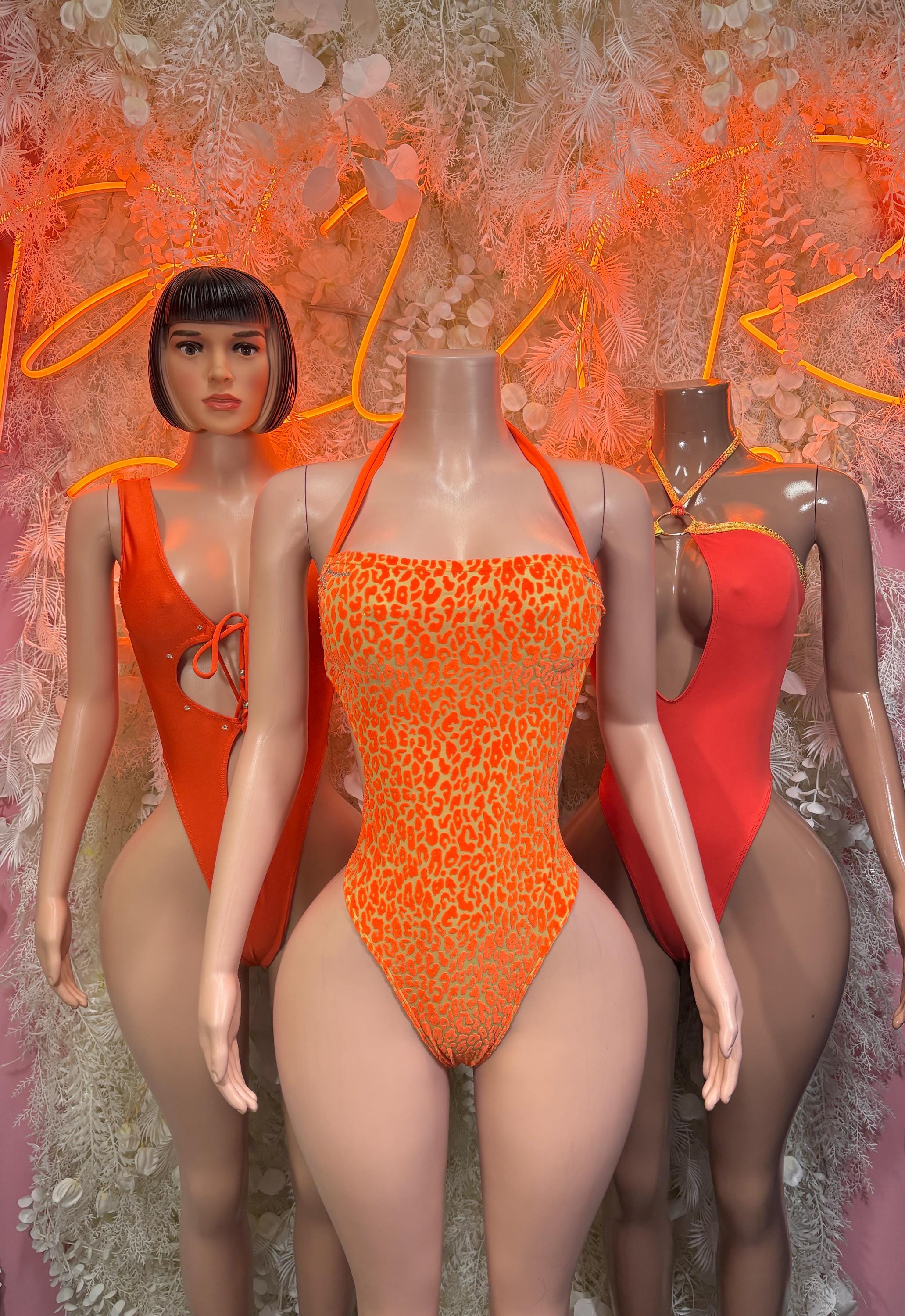 Orange leopard-print one-piece bodysuit with halter neckline and high-cut legs
