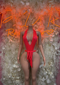Coral red one-piece festival swimsuit with halter neckline and front tie waist