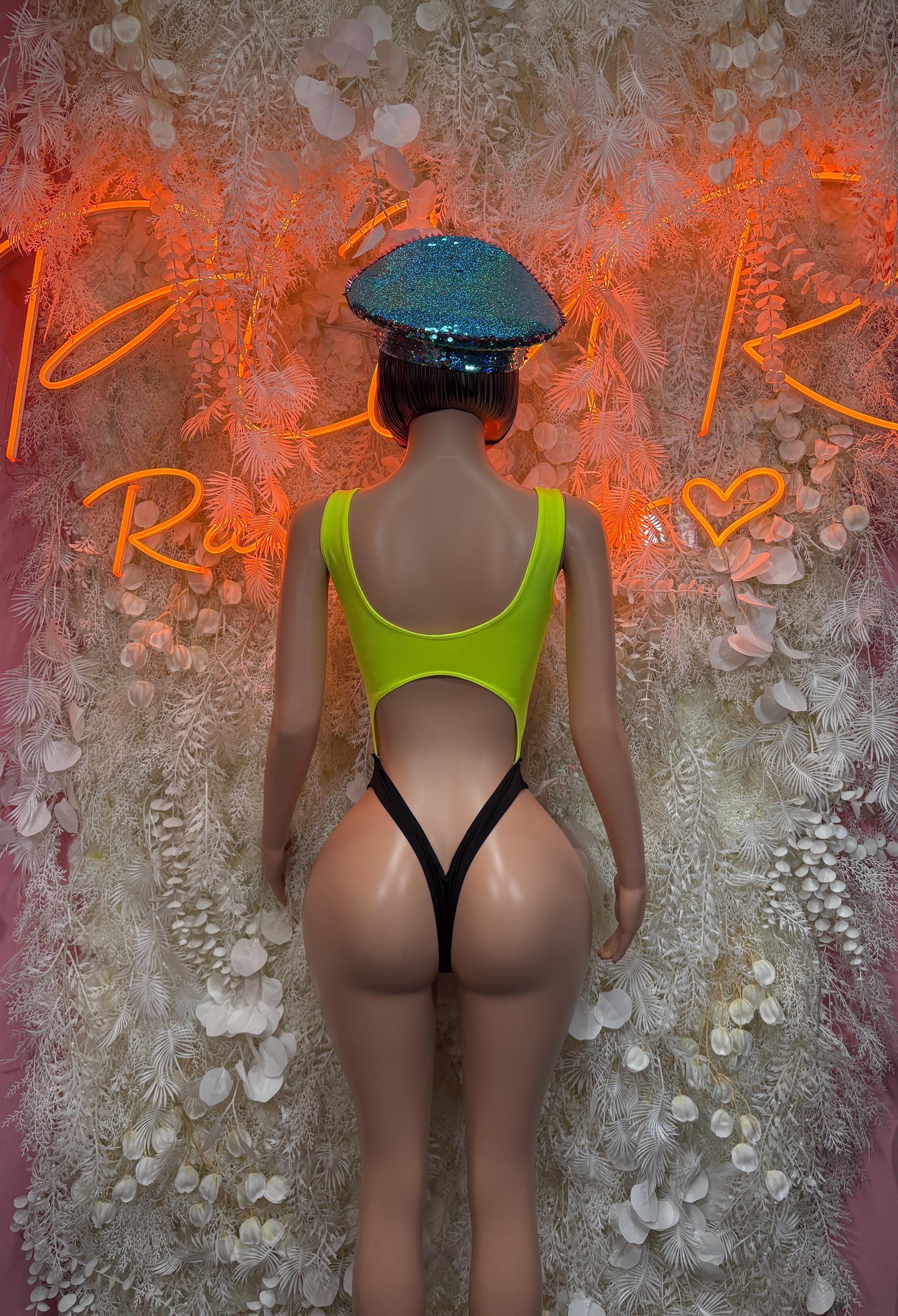 Neon green one-piece festival bodysuit with open back and black thong straps