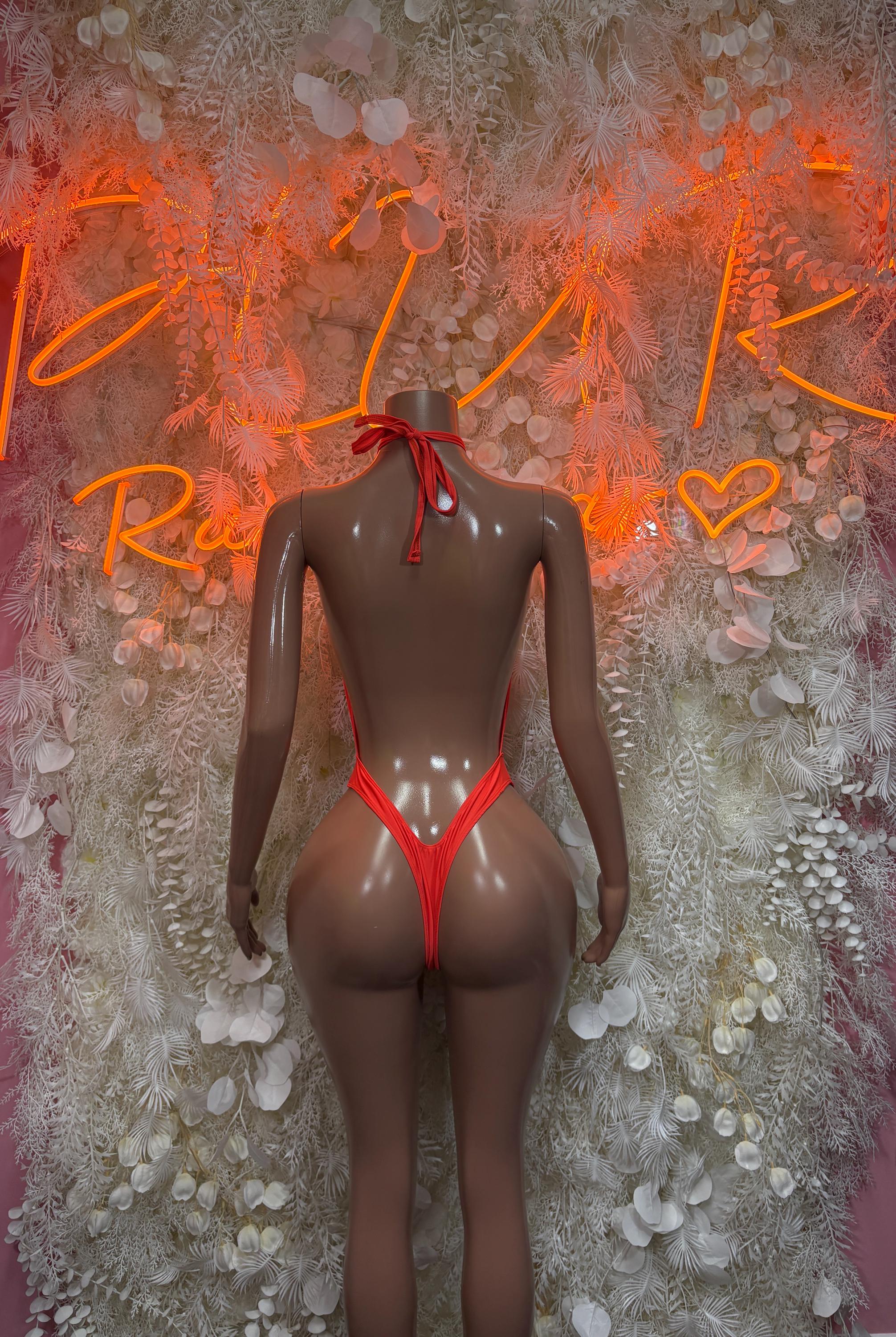 Red string-tie one-piece swimsuit with open back and V-shaped bottom