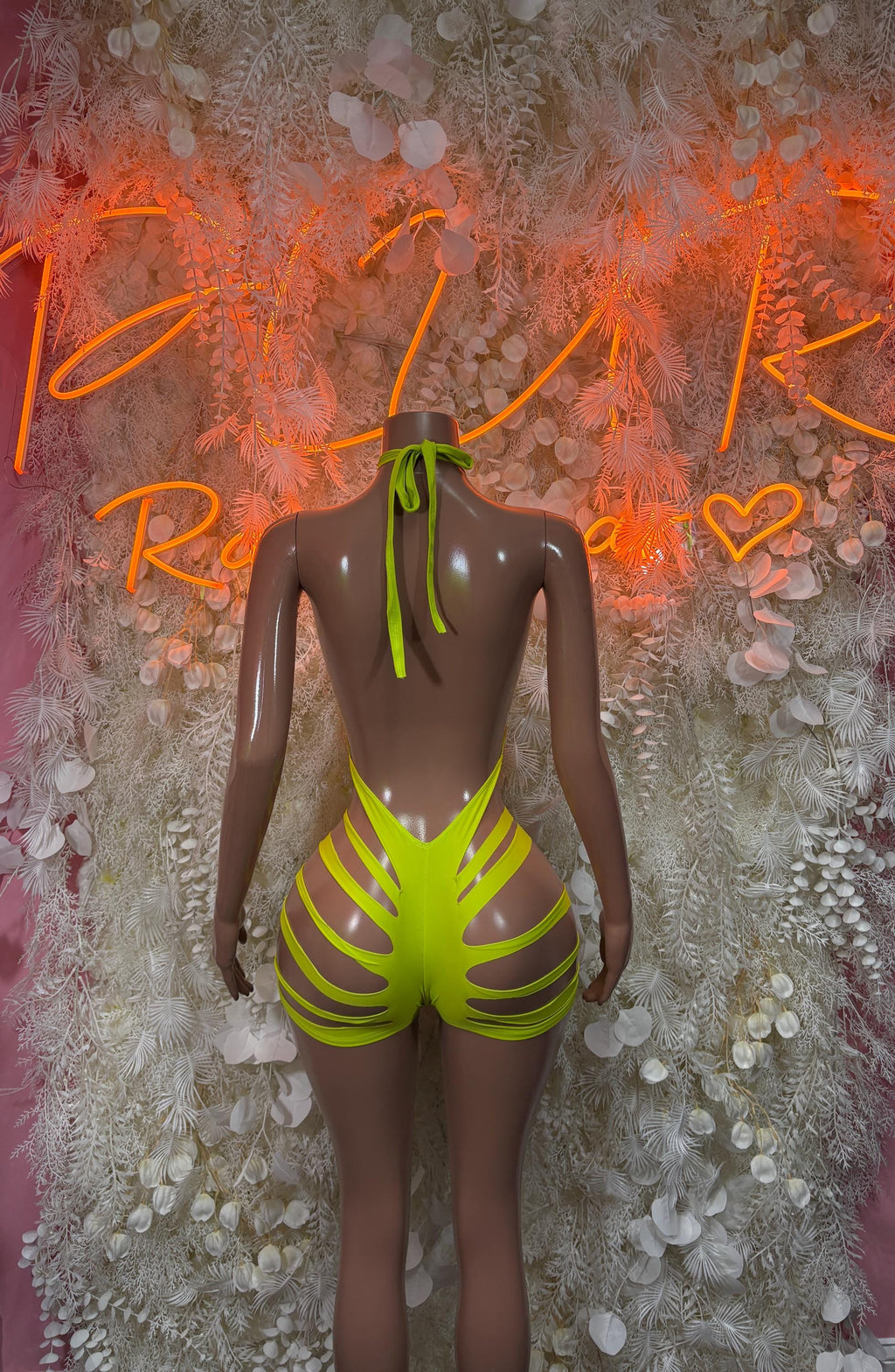 Neon green halter one-piece with open back and crisscross strap detailing