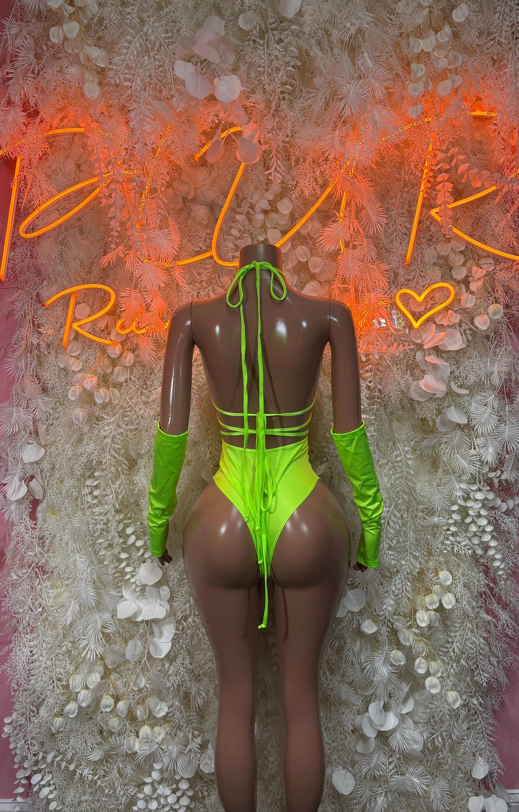 Neon green long-sleeve one-piece rave outfit with crisscross back straps