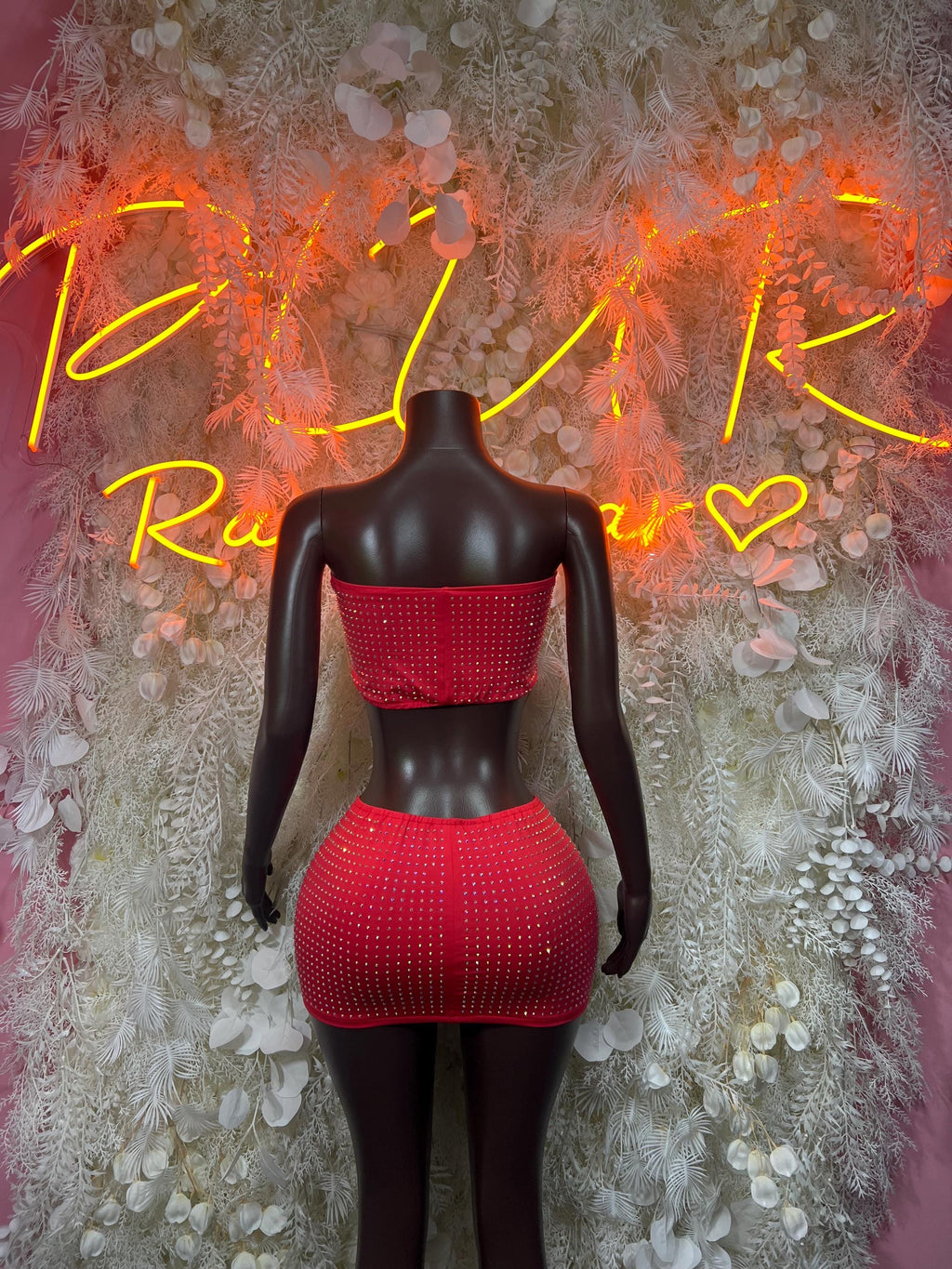 Red rhinestone bandeau crop top and high-waist mini skirt on mannequin, full front