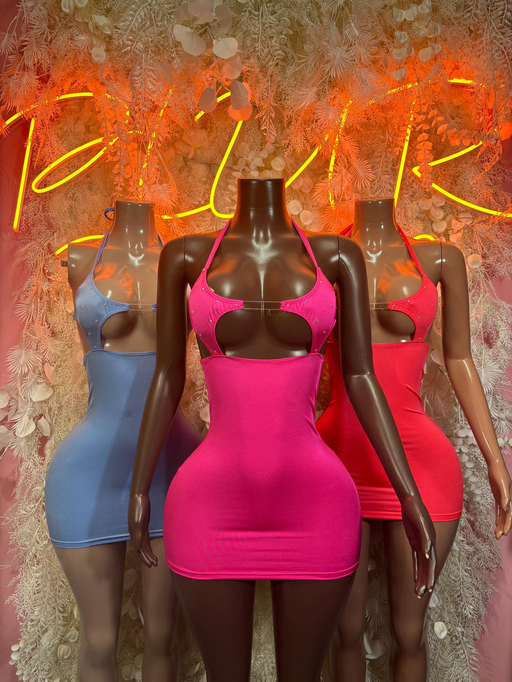 Three rave dresses: magenta front mini with halter cutout, blue and red behind