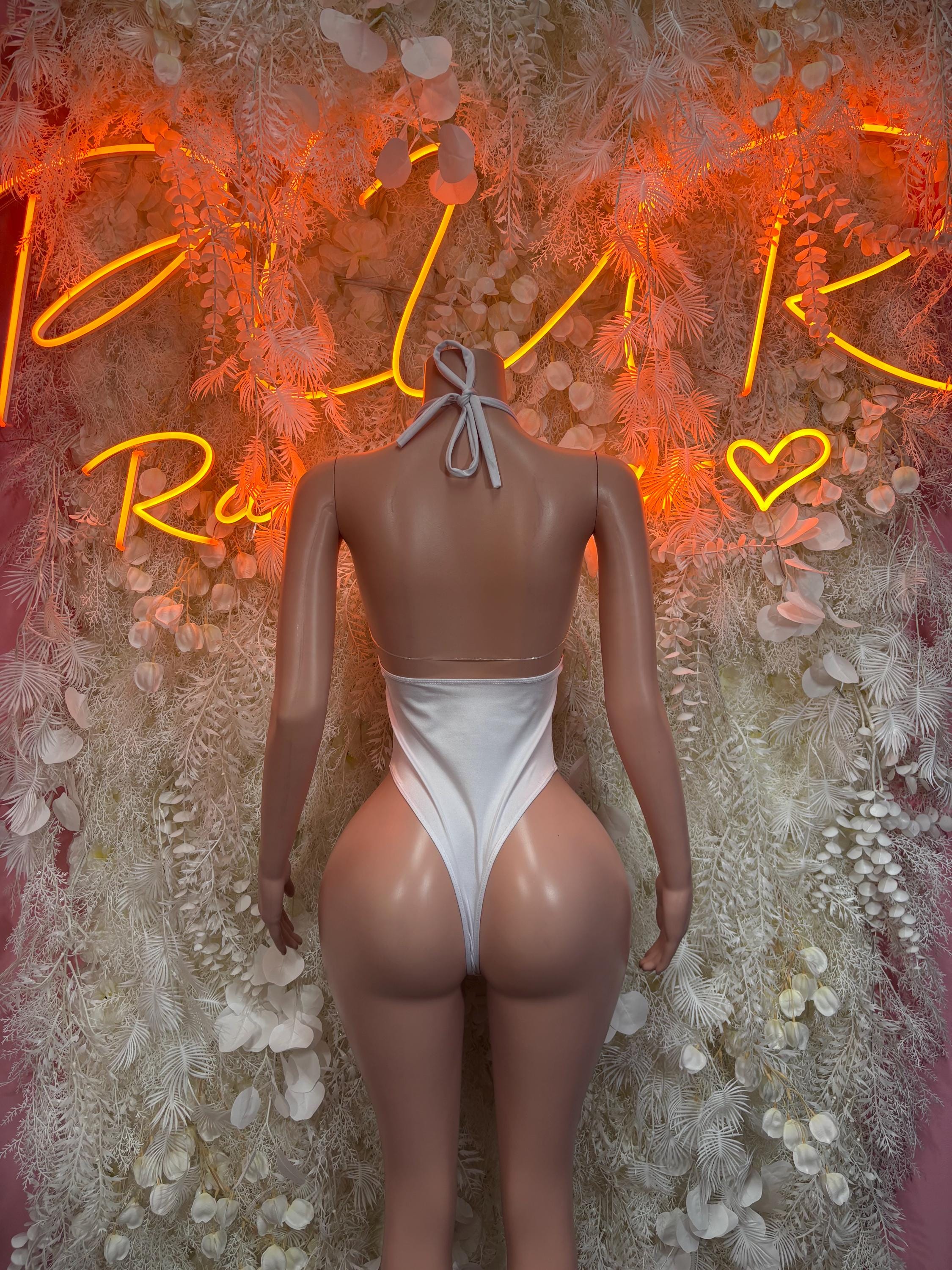 White one-piece bodysuit with tie neck straps and low back