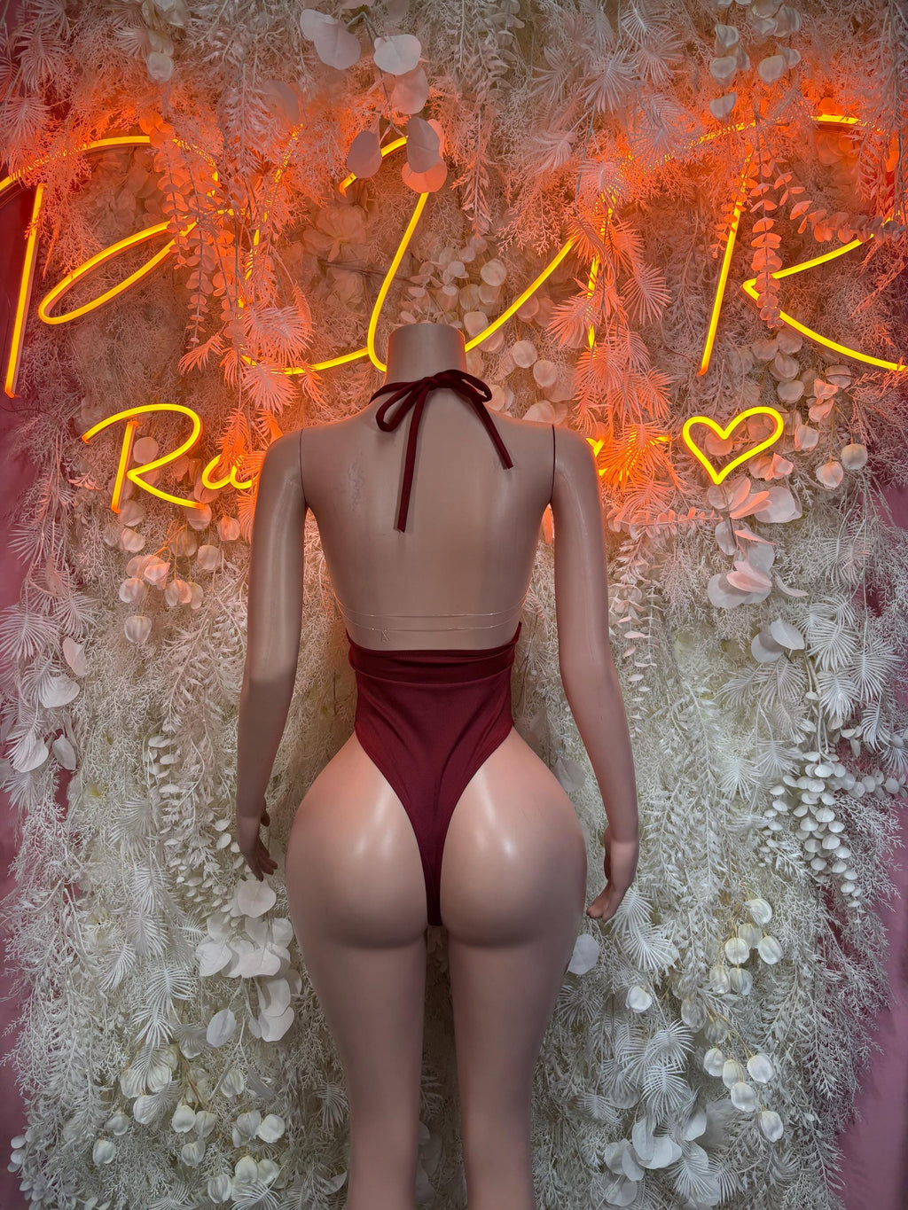 Burgundy backless sleeveless bodysuit with knotted neck tie and high-cut leg