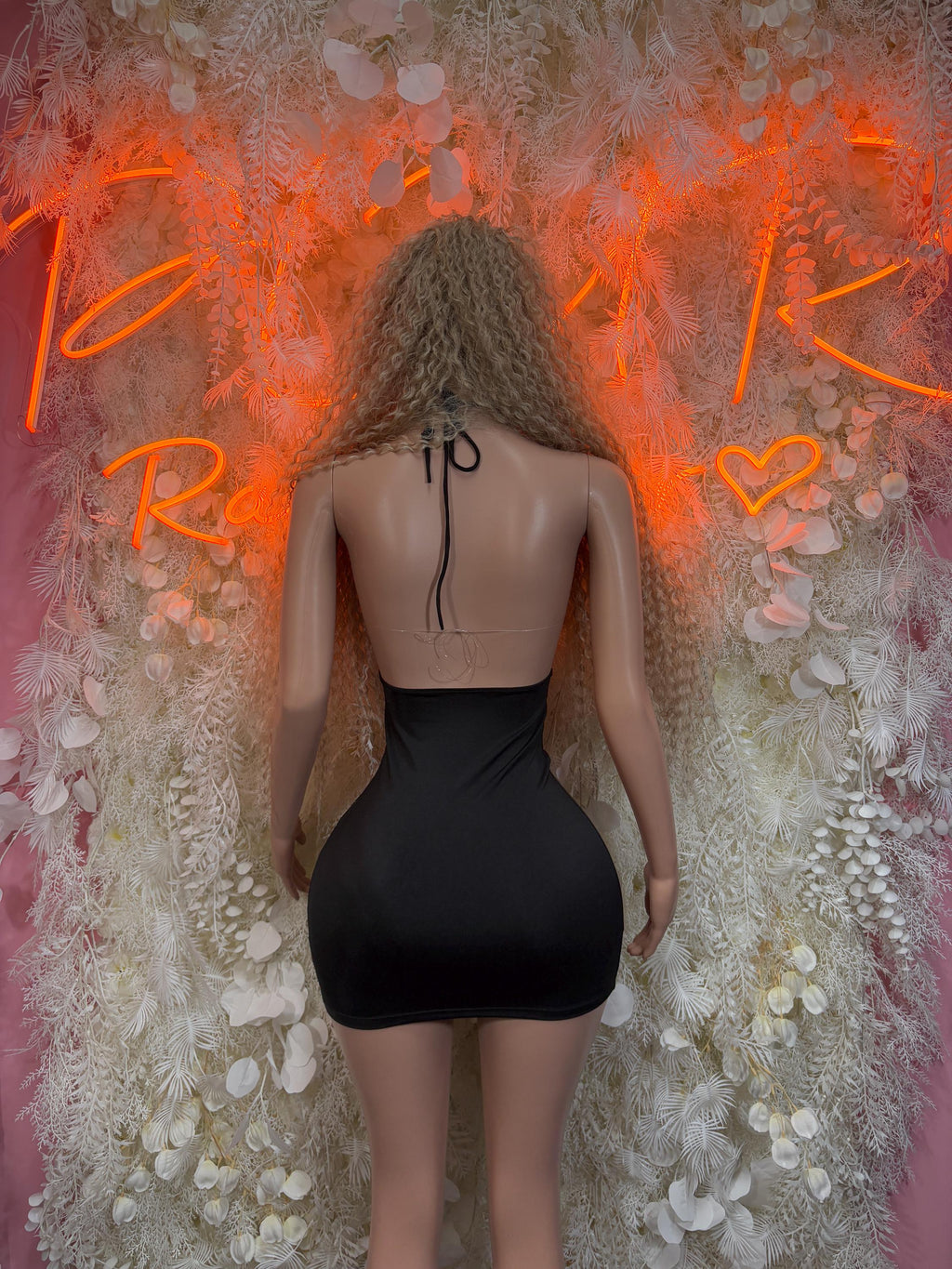 Back view of black mini dress with rose gold lace halter and lace-up ties