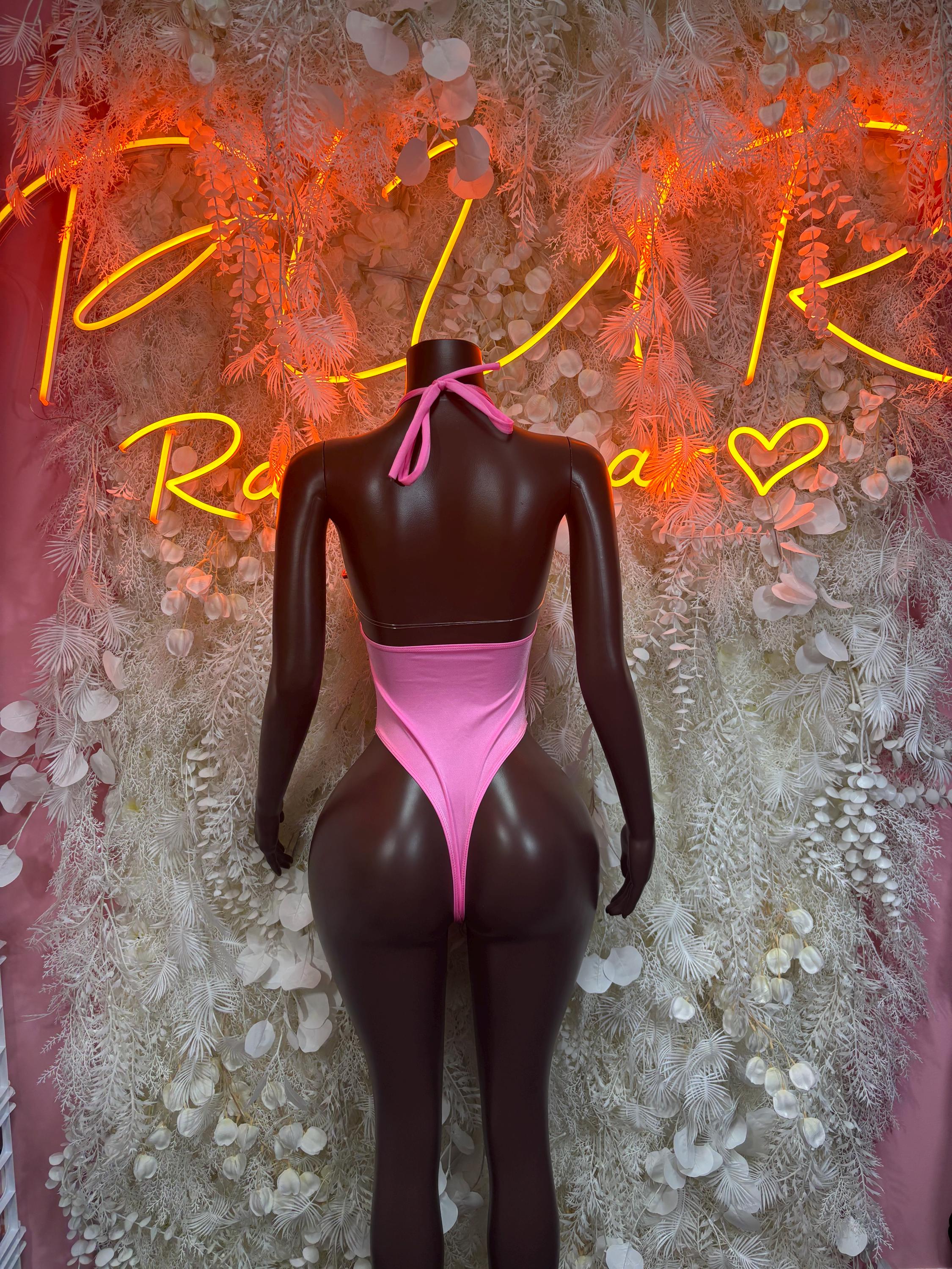 Pink one-piece halter bodysuit with crisscross tie back and high-cut legs
