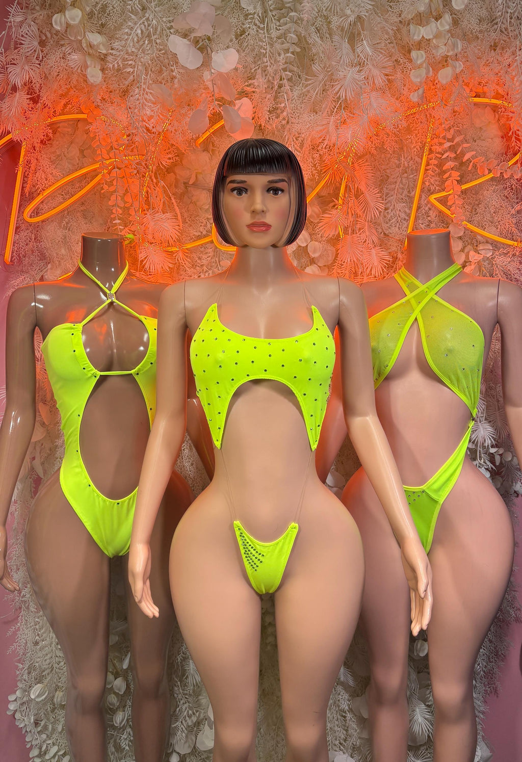 Neon green one-piece bodysuit with triangle center cutout and thin shoulder straps