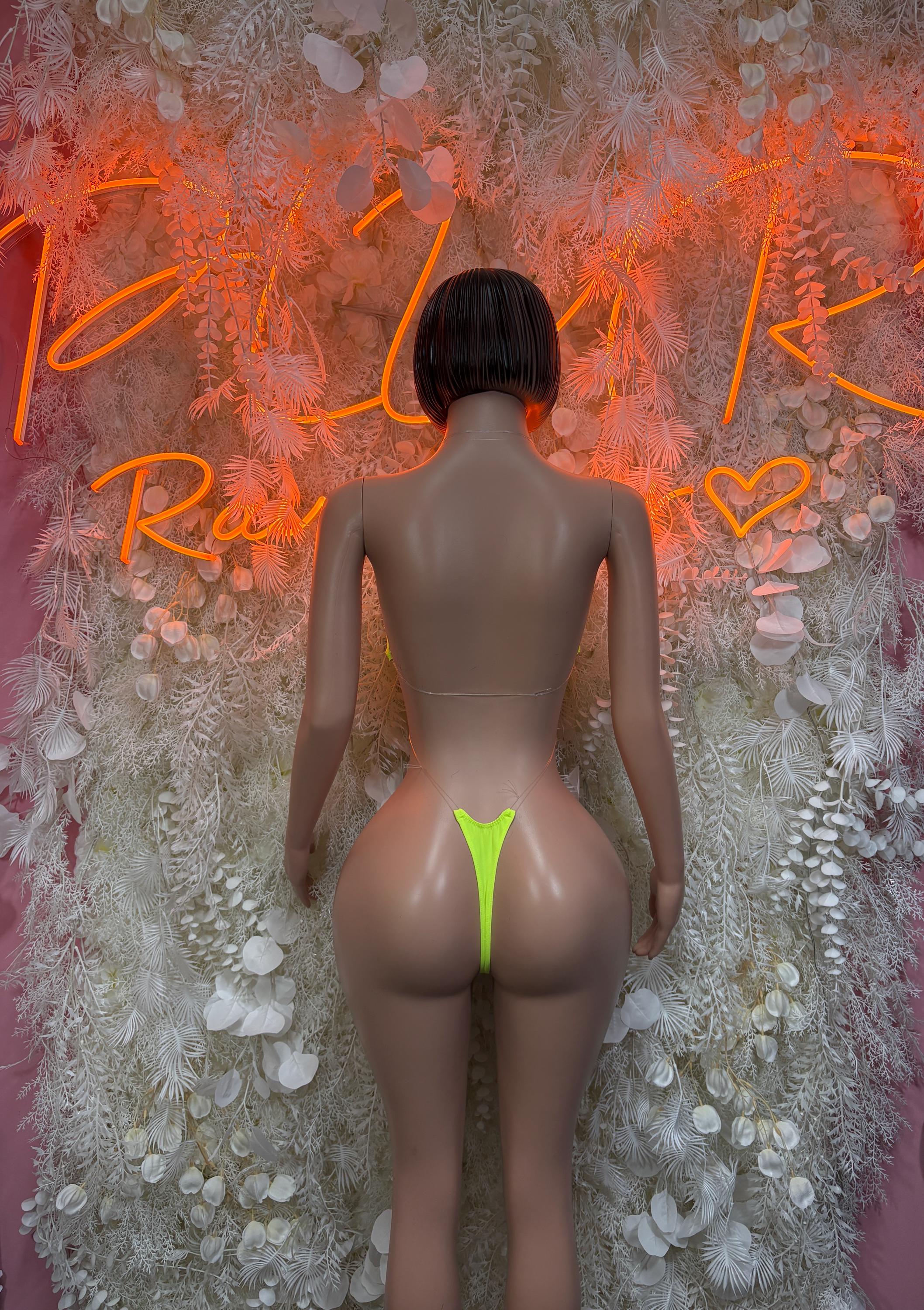 Neon green slingshot one-piece bodysuit from back with thin straps and cutout