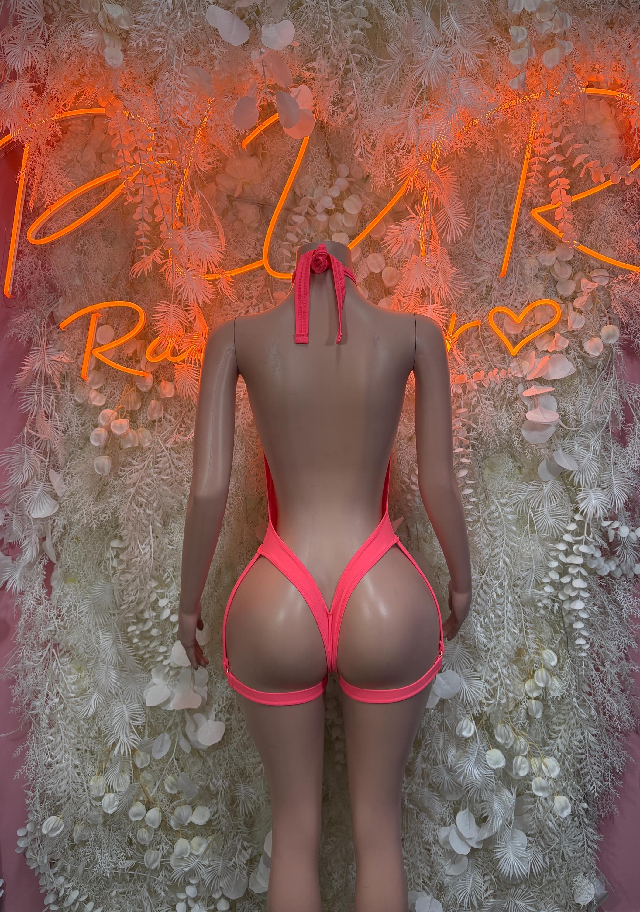 Coral one-piece bodysuit with back bow tie and V-neck front