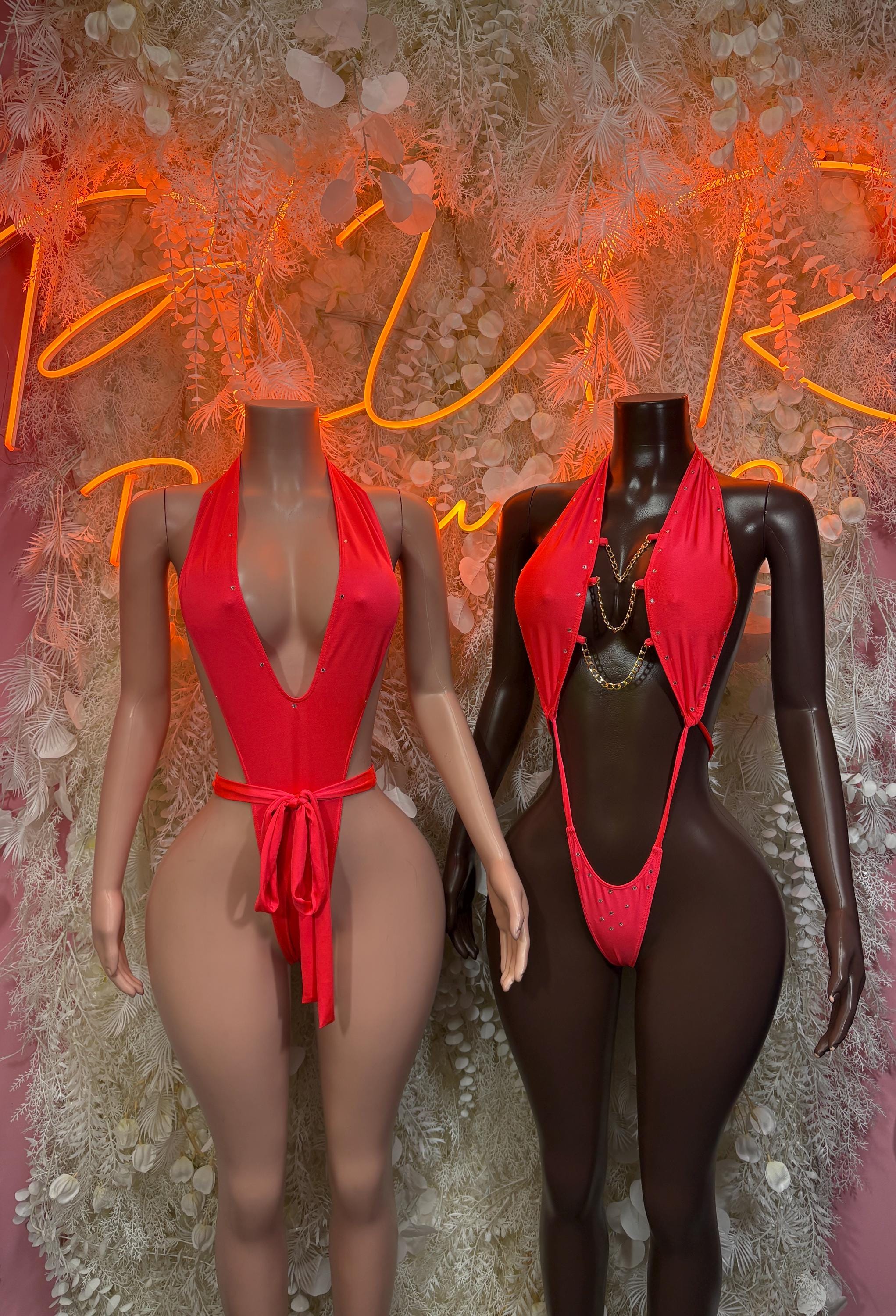 Coral red and black one-piece festival swimsuits, halter styles side view