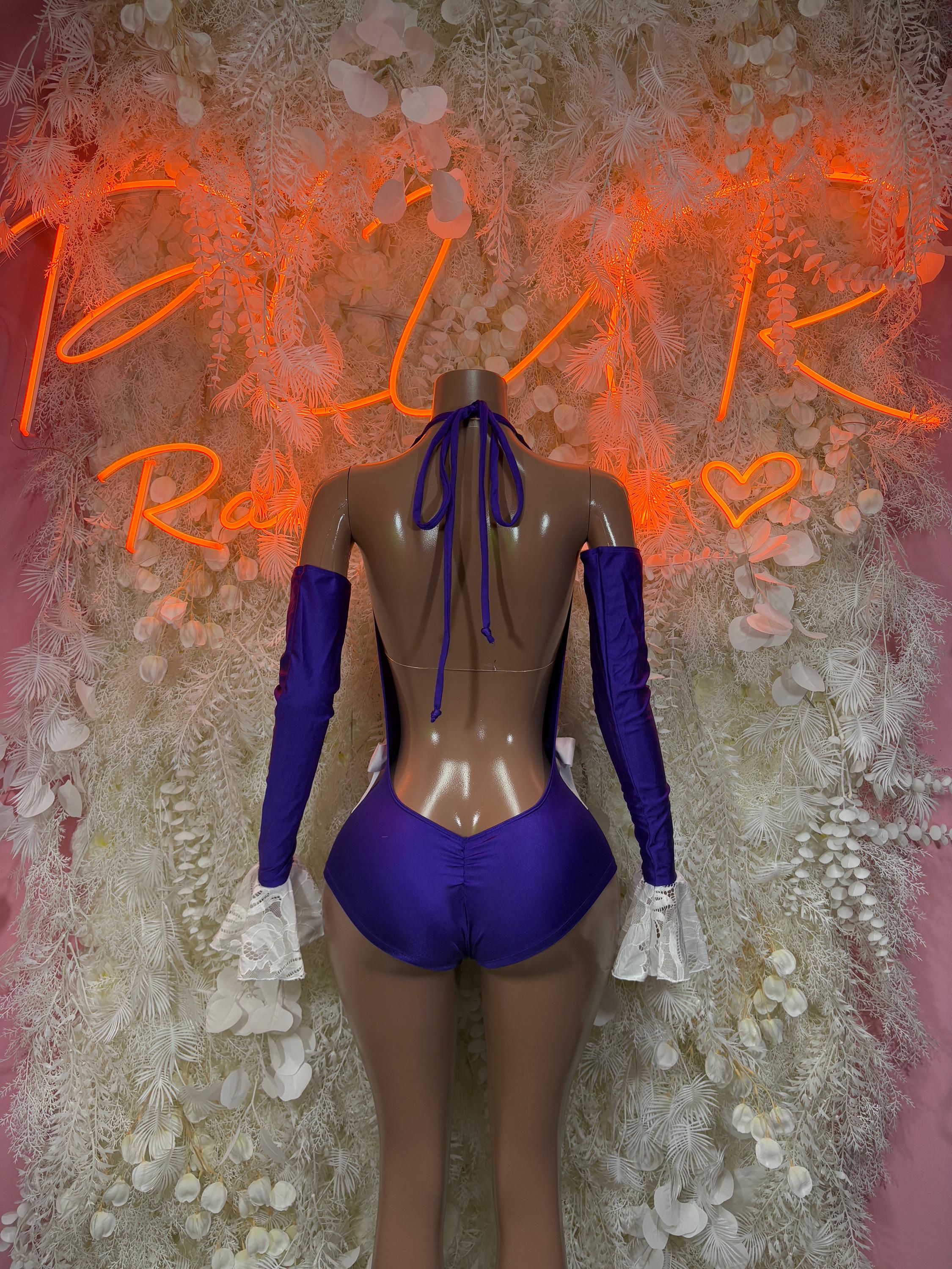 Purple backless rave bodysuit with long sleeves, lace triangle cups, and tie bow