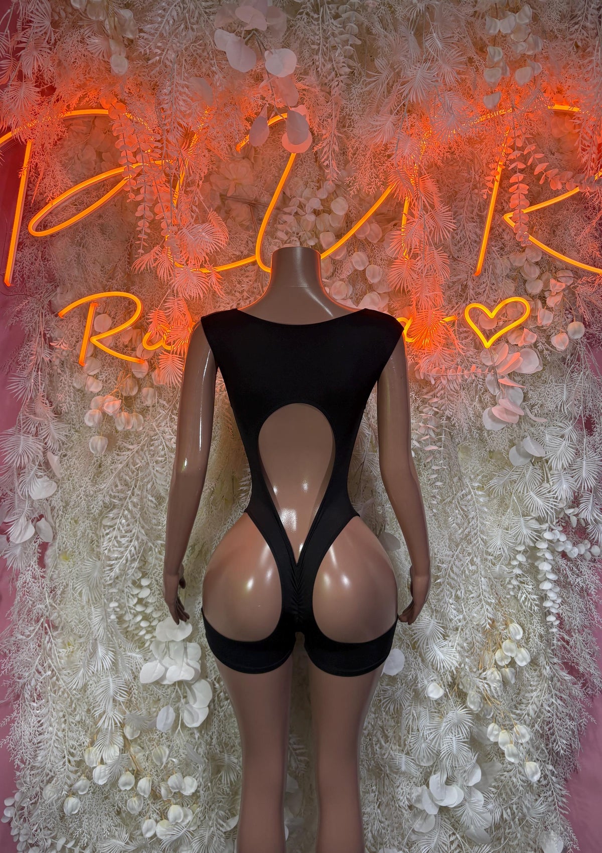 Black one-piece rave bodysuit with high neckline and large chest cutout