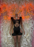 Black rave bodysuit with lace-up front, crisscross straps, sheer cutout panels