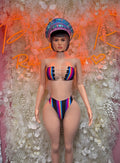 Multicolor two-piece festival outfit: bandeau top, high-cut bottoms, matching hat