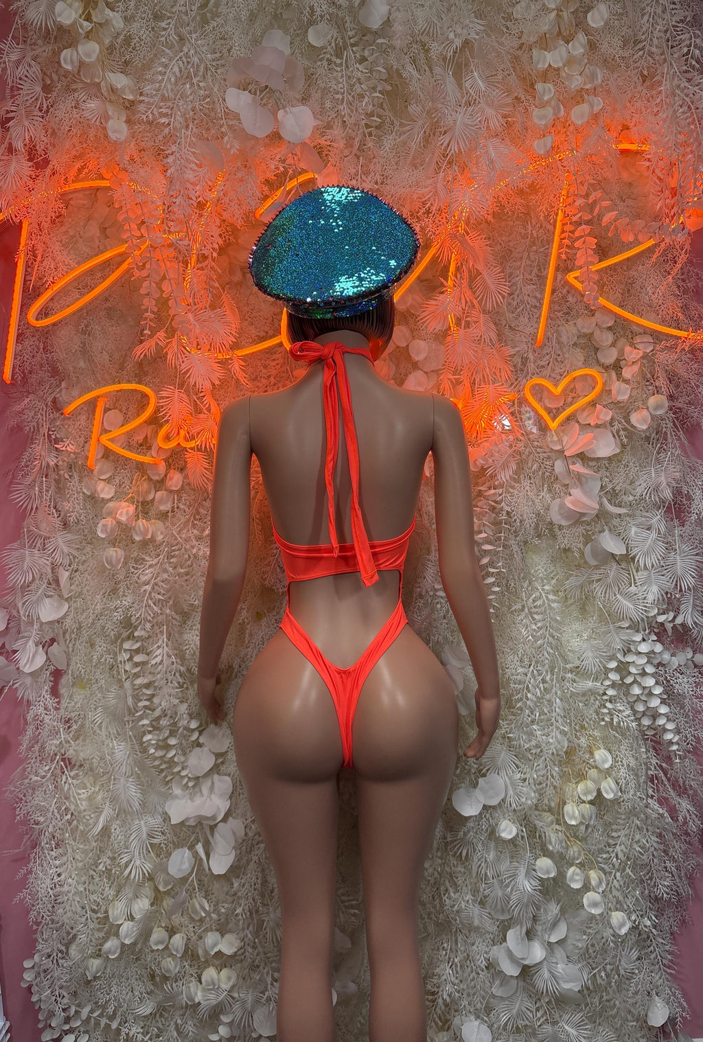 Orange one-piece dancewear with back ties and high-cut leg