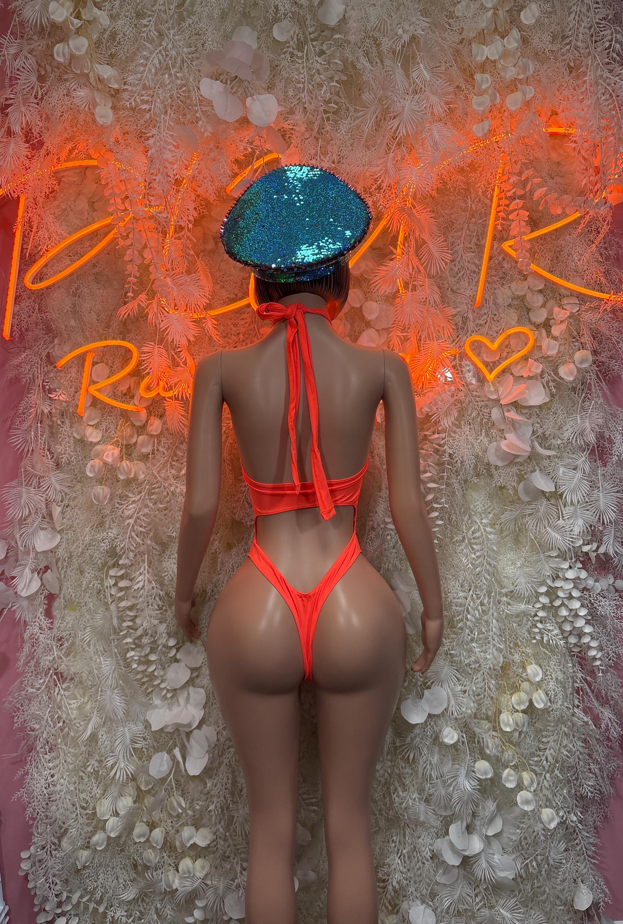 Orange one-piece dancewear with back ties and high-cut leg
