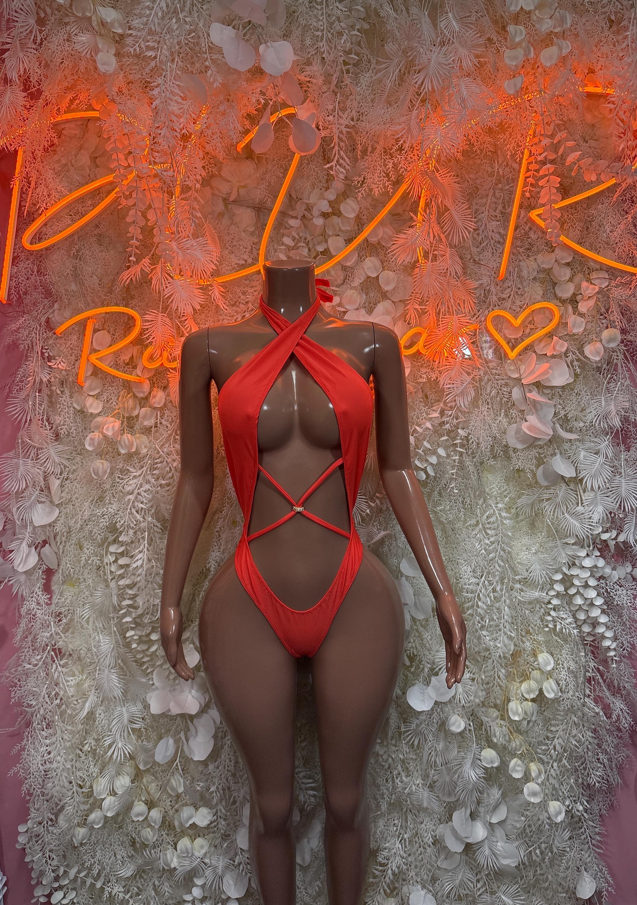 Red halter one-piece swimsuit with crisscross straps and cutout back