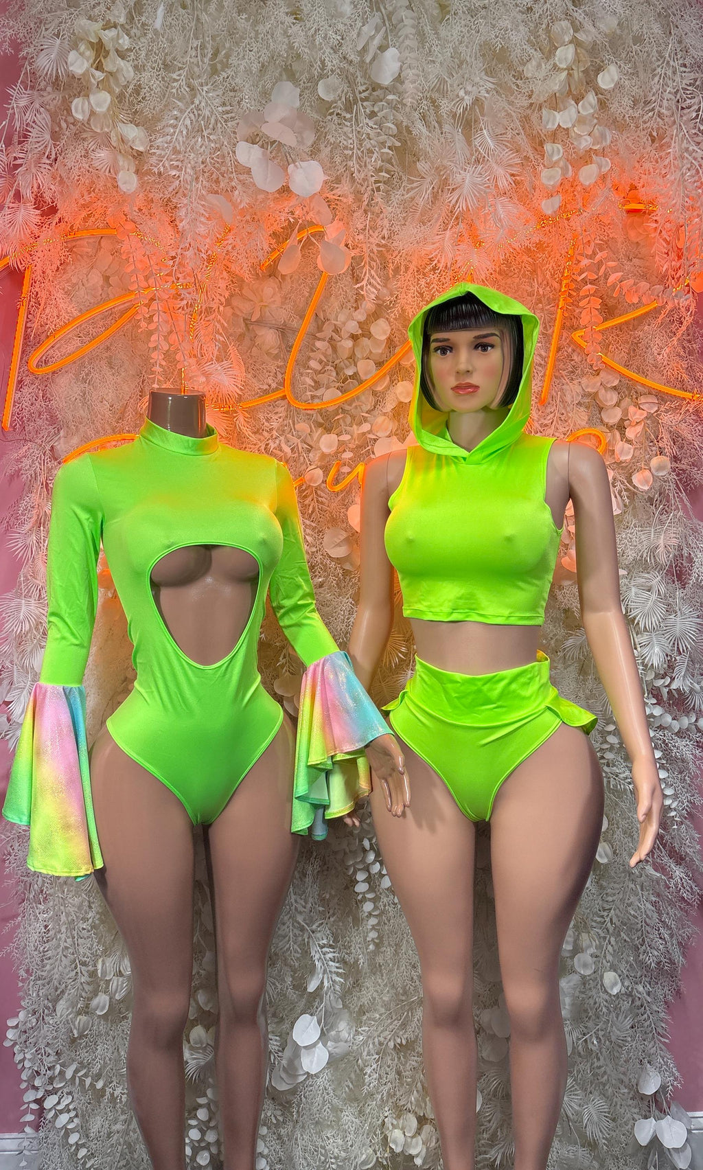Green rave one-piece bodysuit with chest cutout and flared sleeves, worn by model