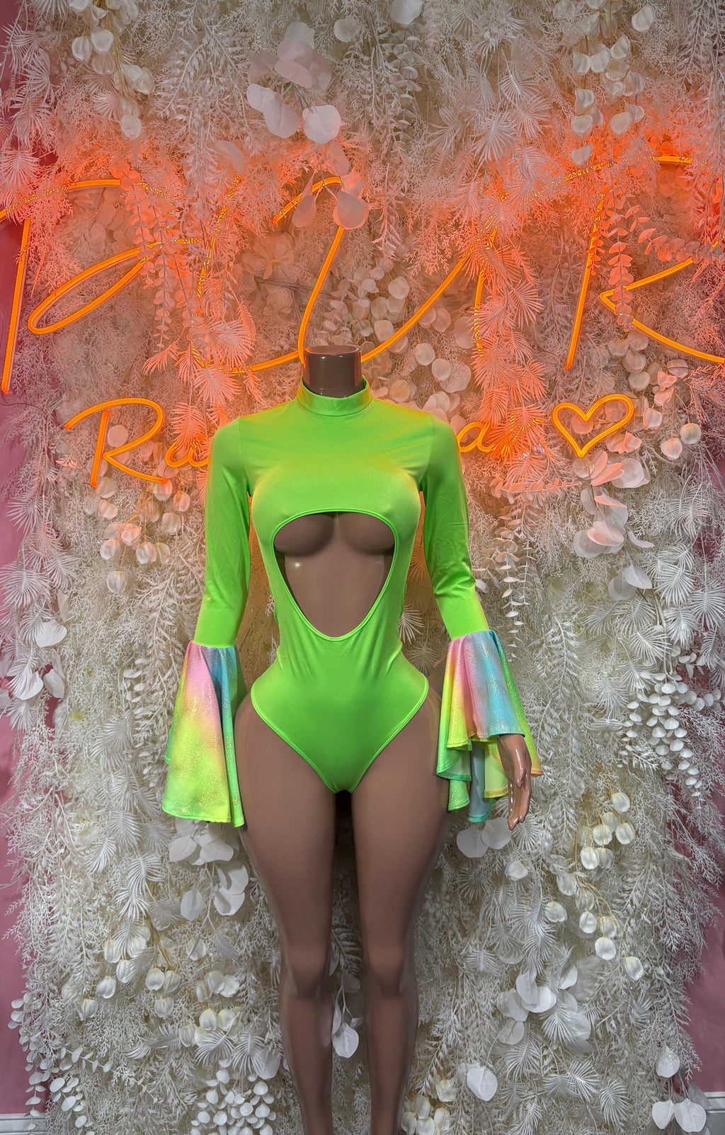 Green one-piece rave bodysuit with cutout chest and flared bell sleeves with iridescent cuffs