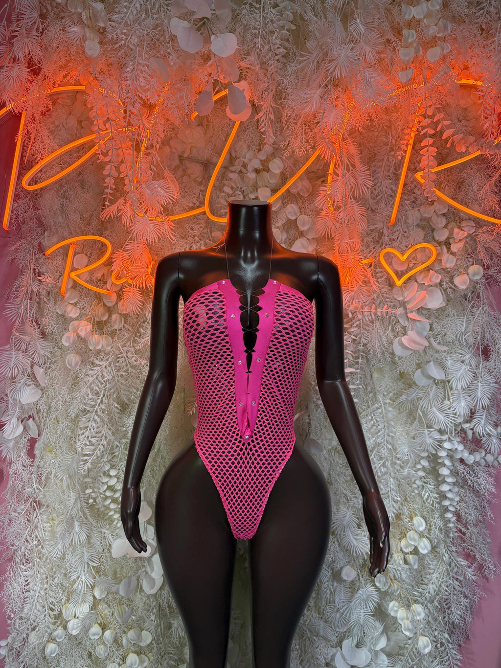 Pink fishnet rave bodysuit with V-neck and thong front