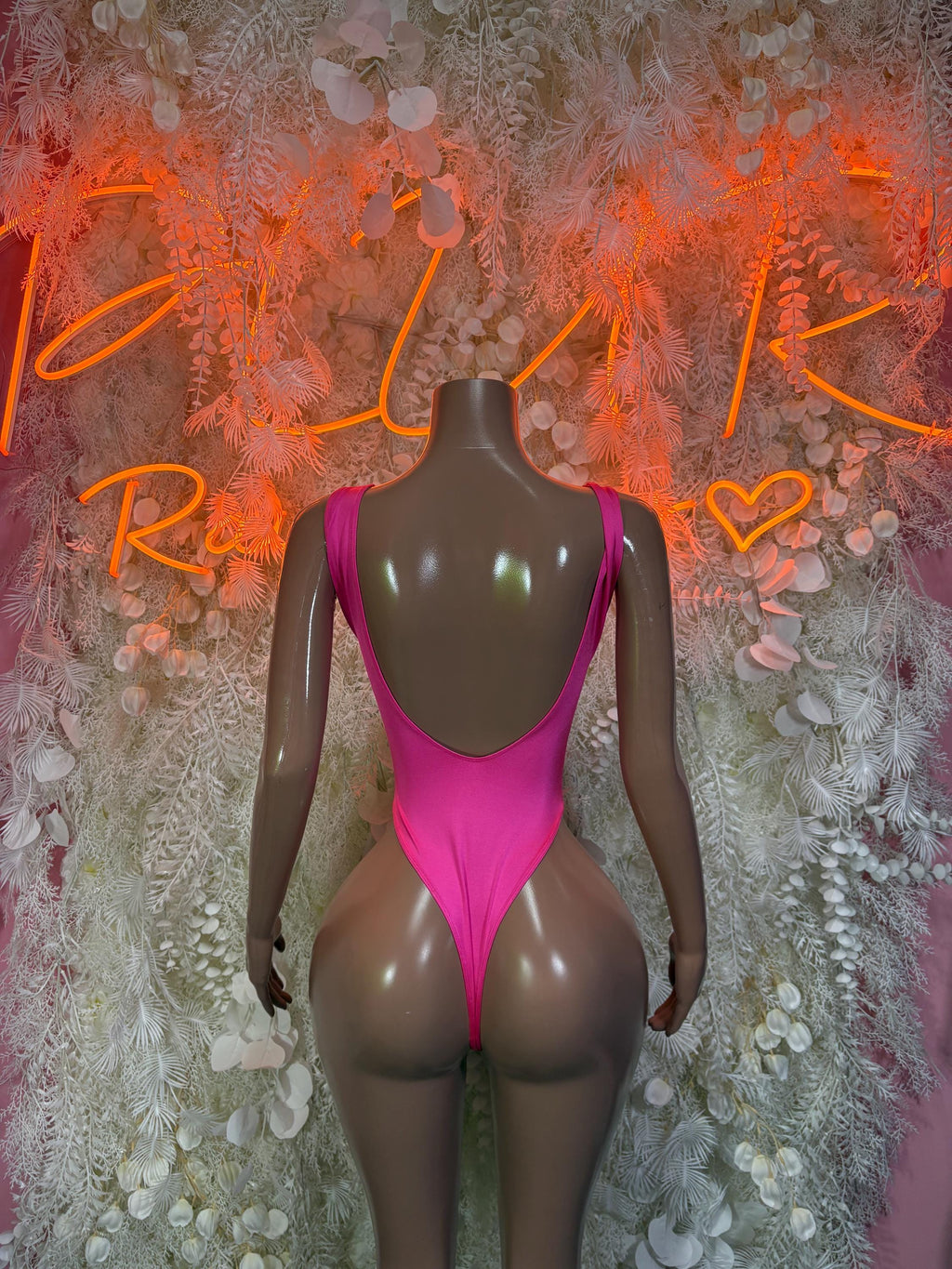 Pink metallic halter bodysuit with open back and high-cut legs