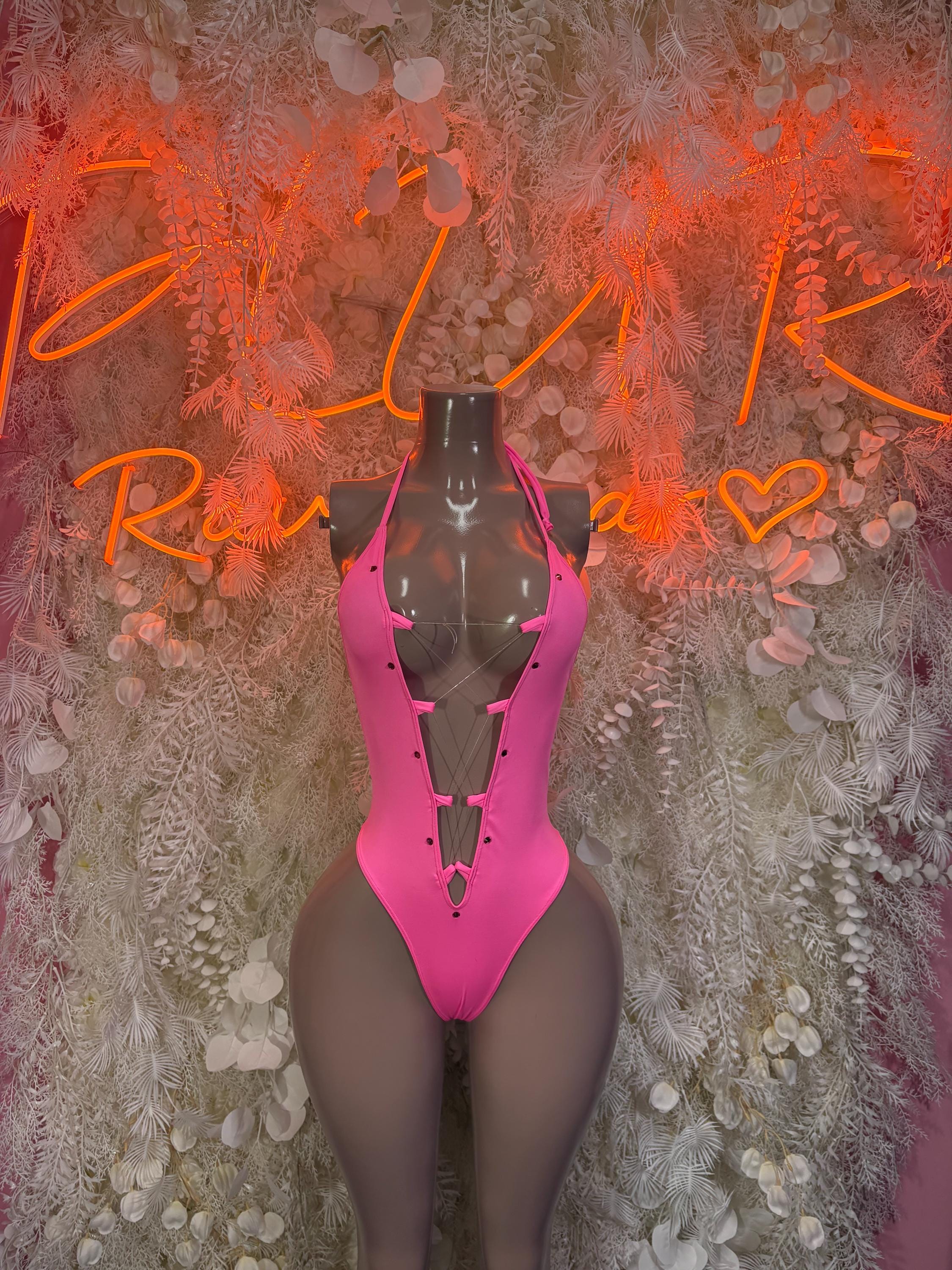 Pink halter bodysuit with cutout front and high-leg one-piece, sheer mesh panels