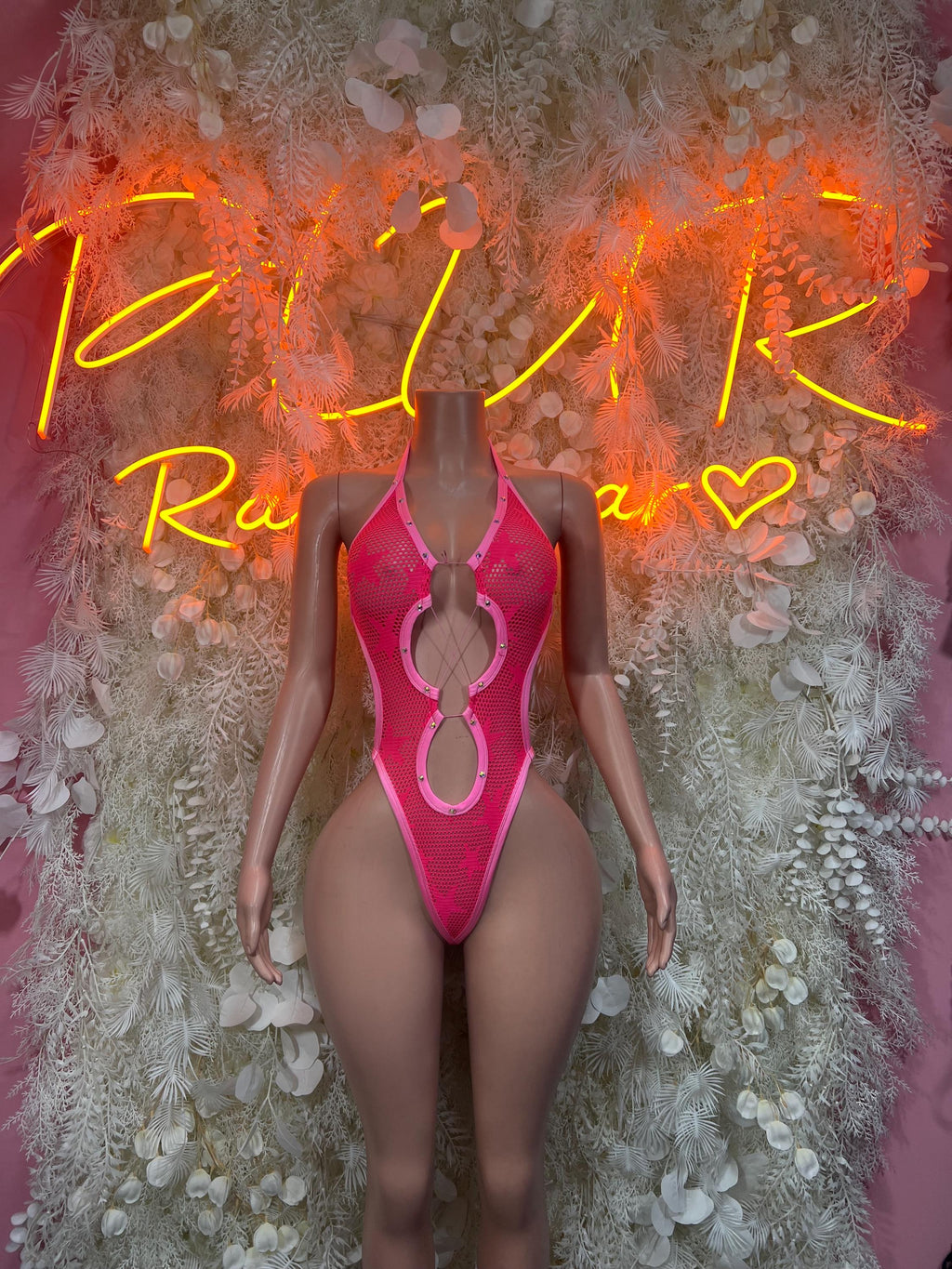 Pink fishnet bodysuit with high-cut legs and teardrop cutout at the center chest