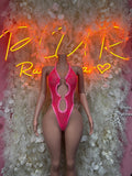 Pink fishnet bodysuit with high-cut legs and teardrop cutout at the center chest