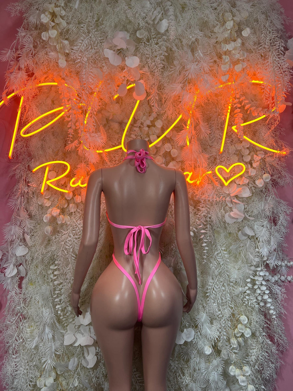 Pink fishnet bodysuit back view with tie straps and high-cut thong back