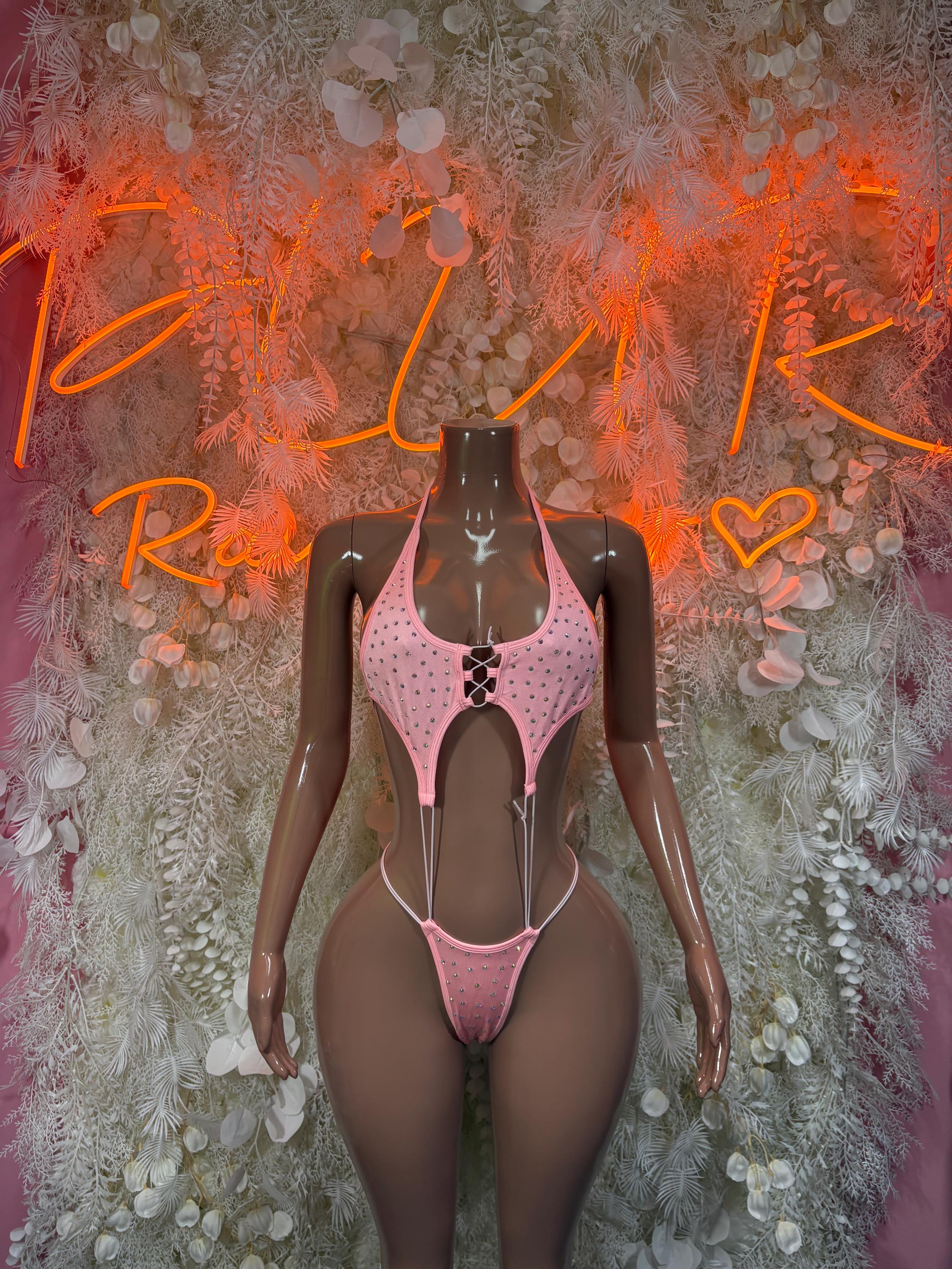 Pink rhinestone one-piece bodysuit with cutout front and strappy tie back