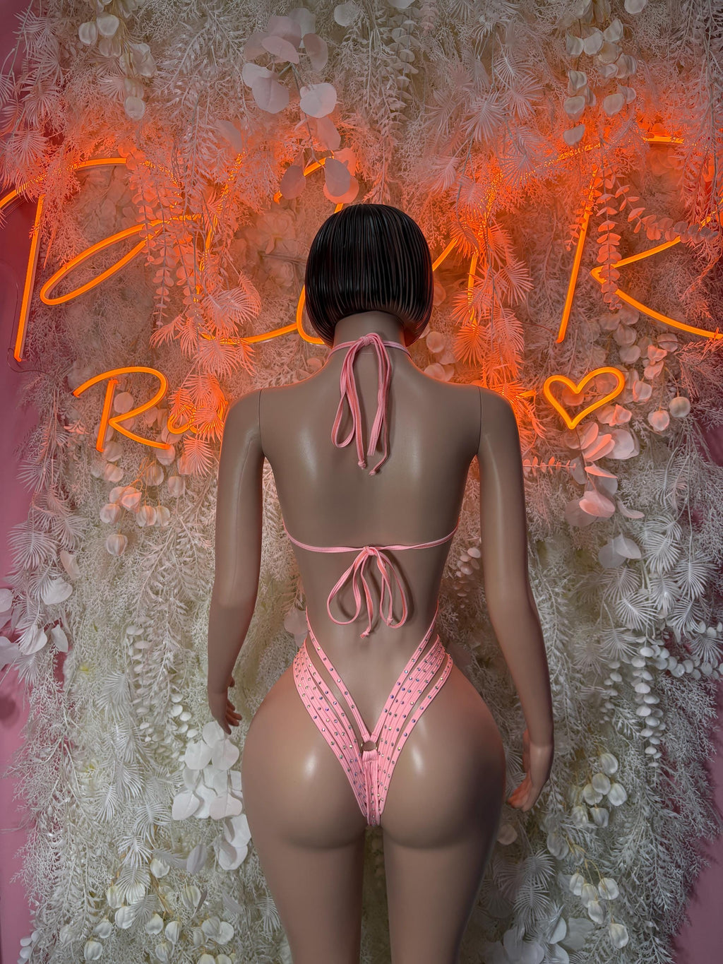 Pink rhinestone one-piece bodysuit back view with lace-tie straps and thong cut