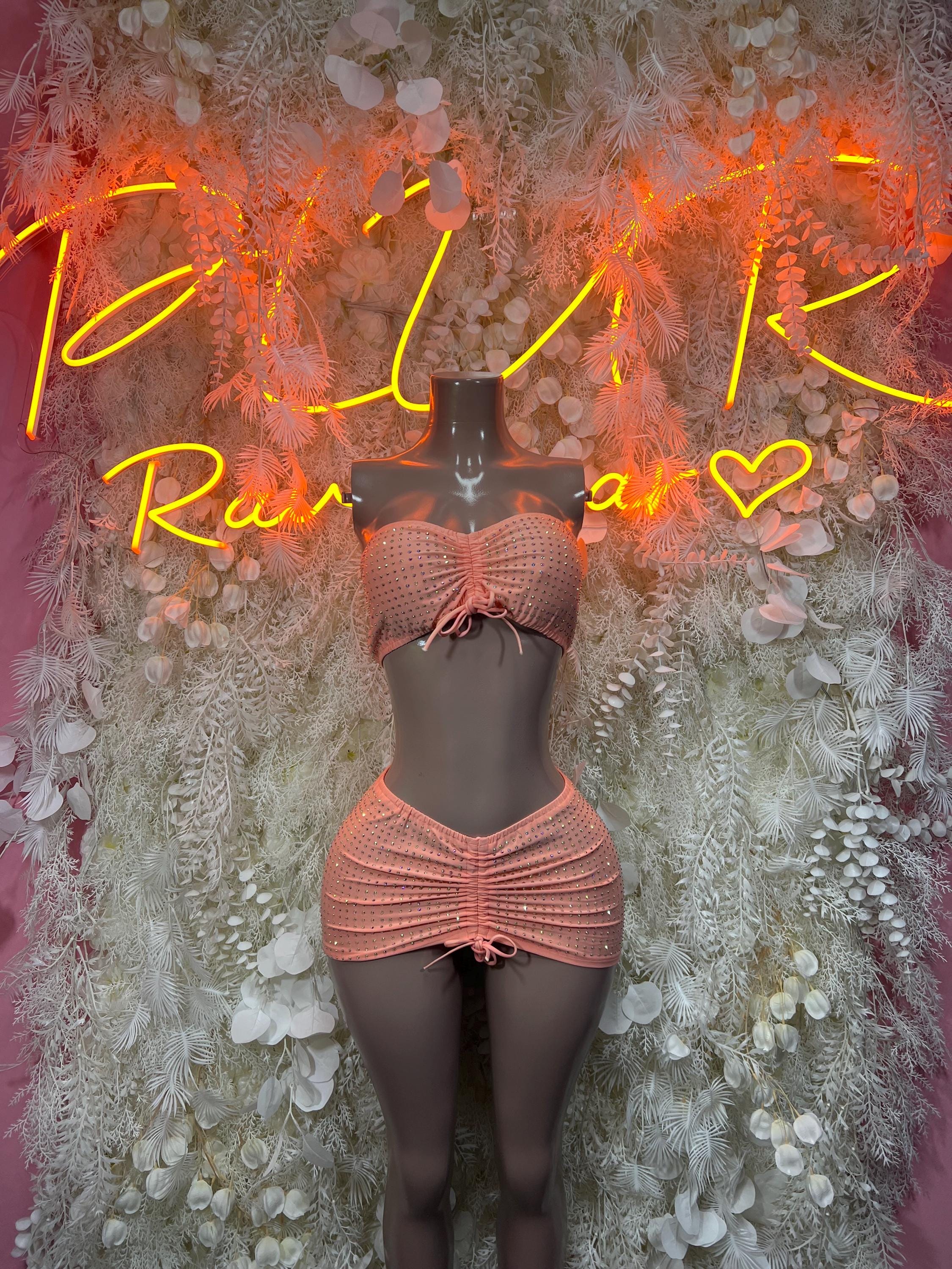 Peach ruched halter top and mini skirt set with bow detail on matching waistband