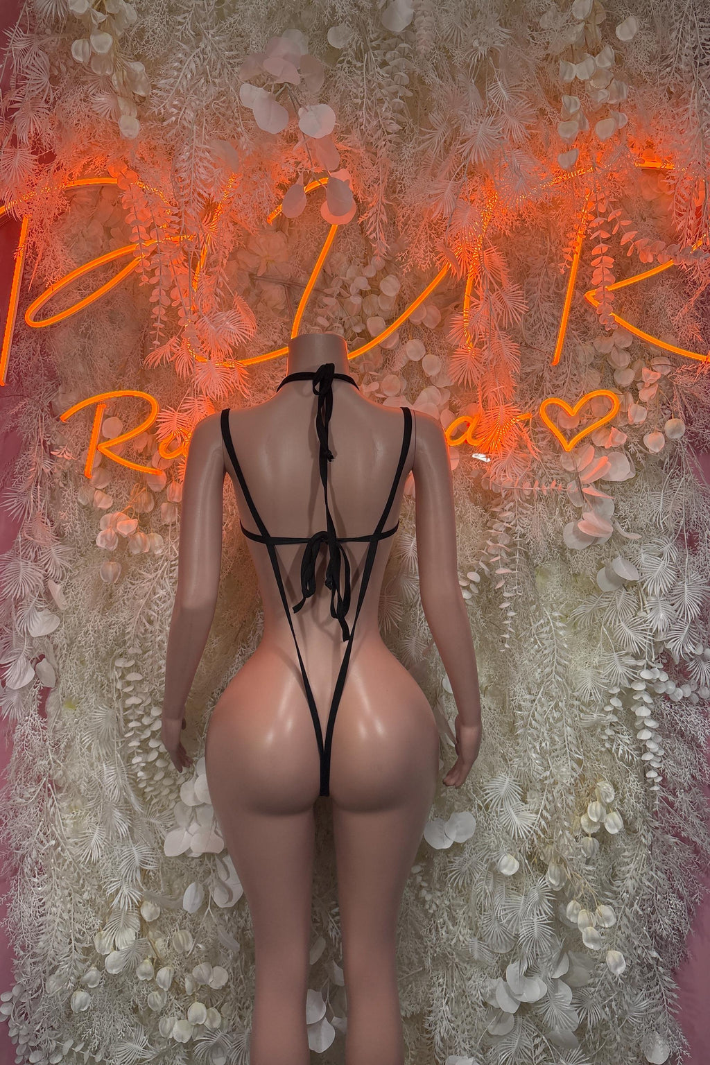 Black one-piece dance bodysuit with crisscross straps and thong back