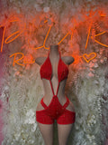 Red rhinestone halter bodysuit with crisscross straps and high-cut shorts