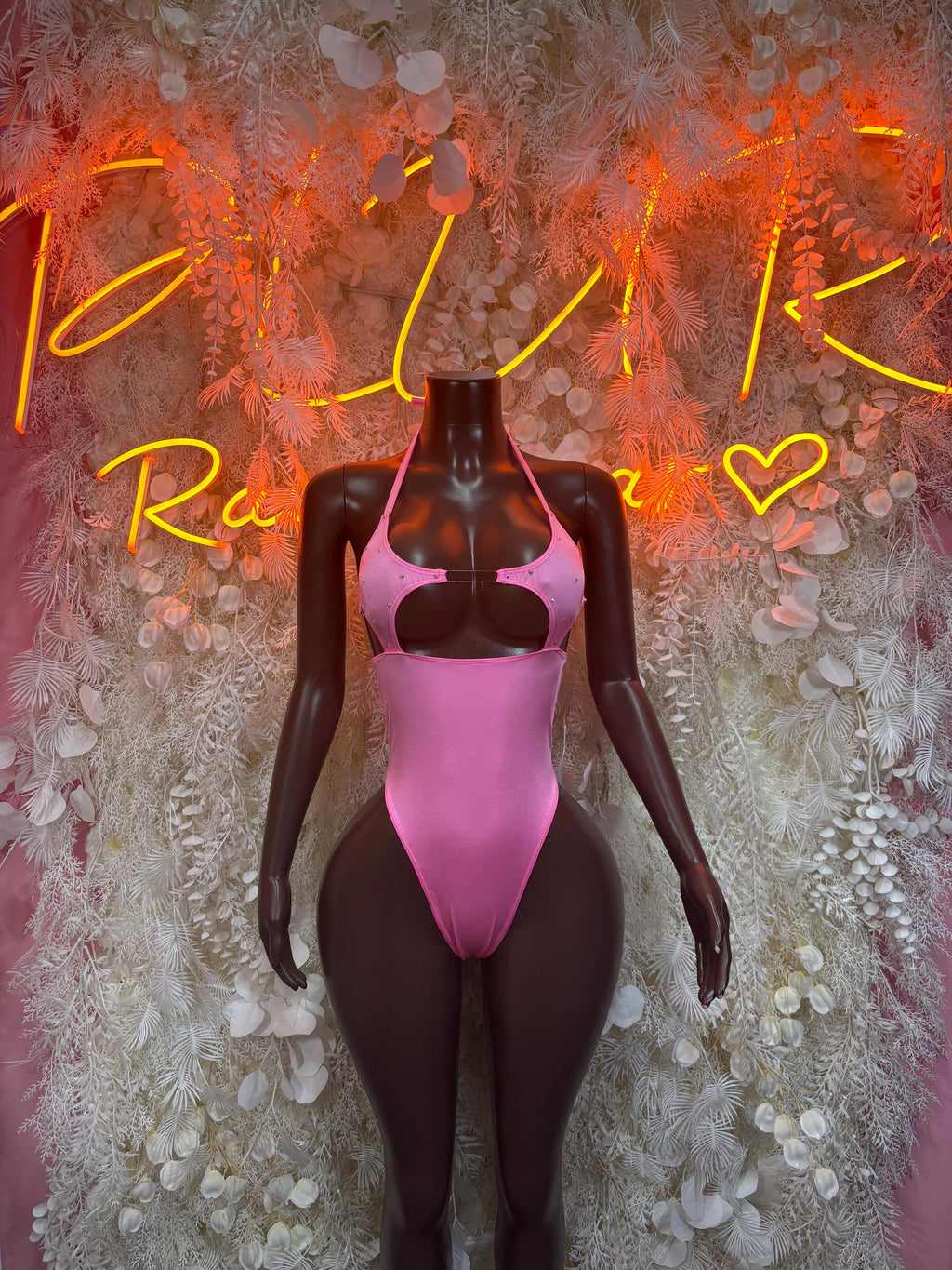 Pink one-piece halter bodysuit with high-cut legs and center chest cutout