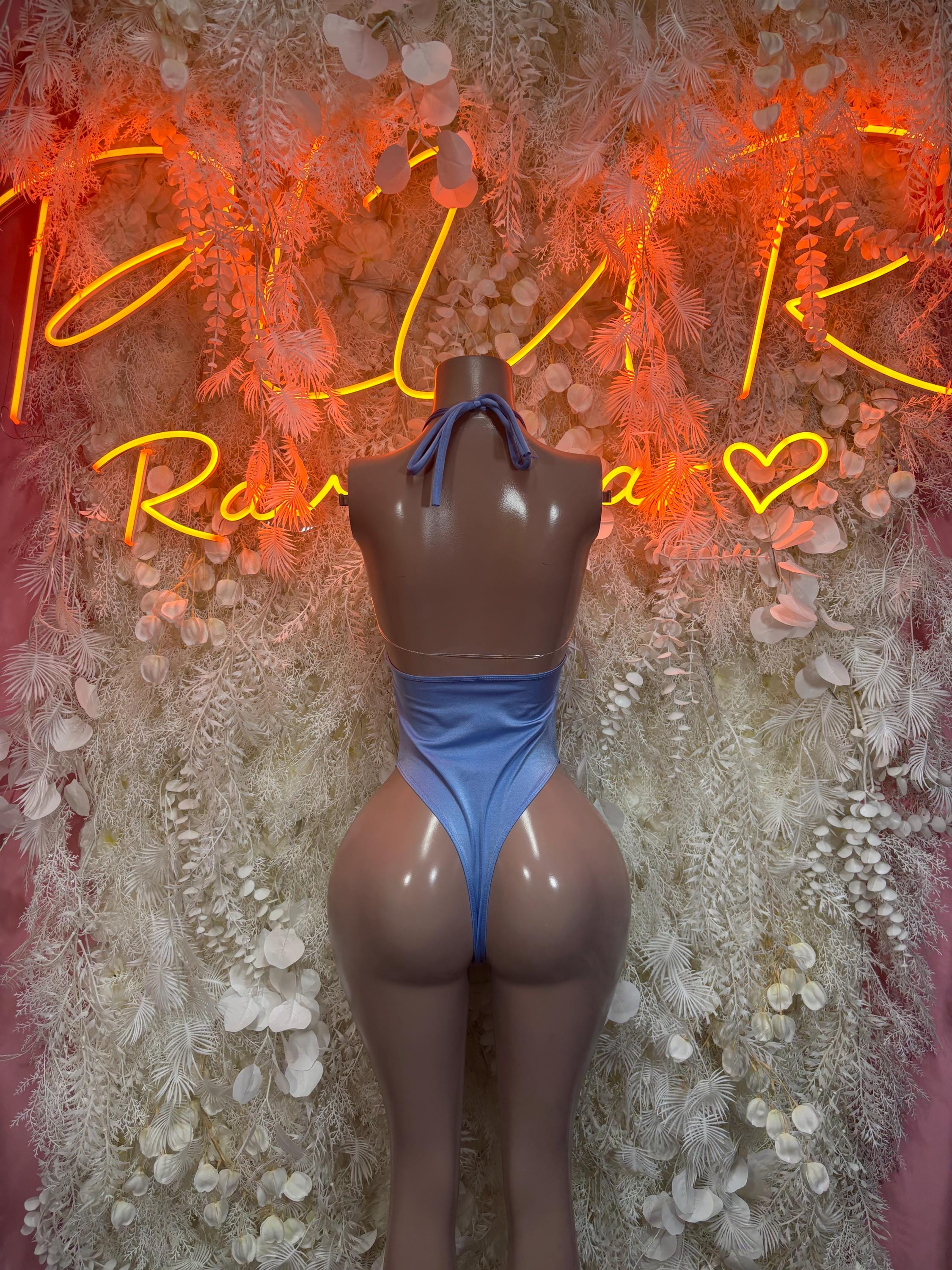 Blue one-piece bodysuit with tie halter straps and high-cut legs