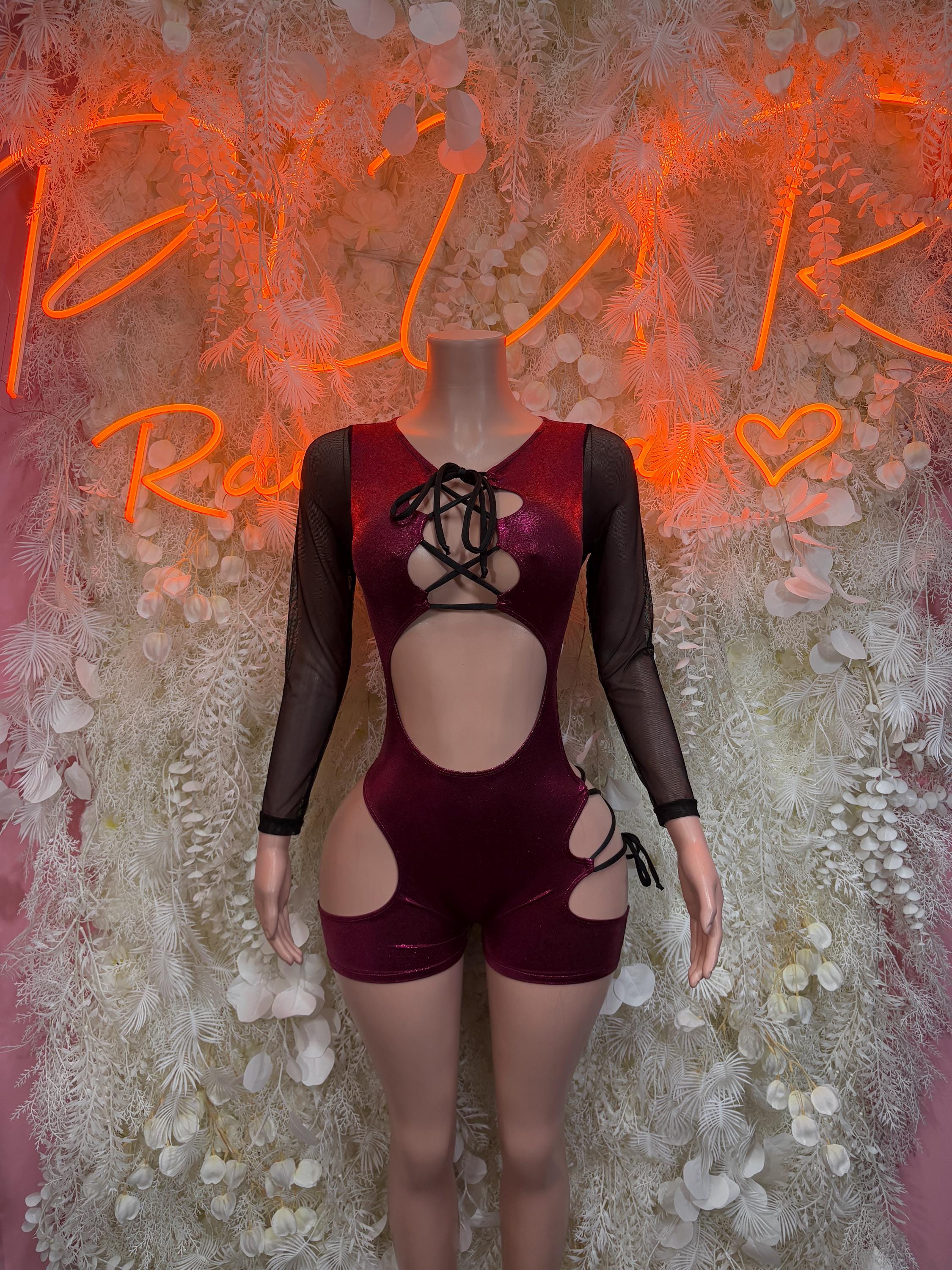 Cherry red lace-up rave bodysuit with sheer long sleeves, crisscross front, side cutouts