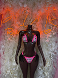 Two-piece rave bikini costume with black base, pink trim, and glittery fringe