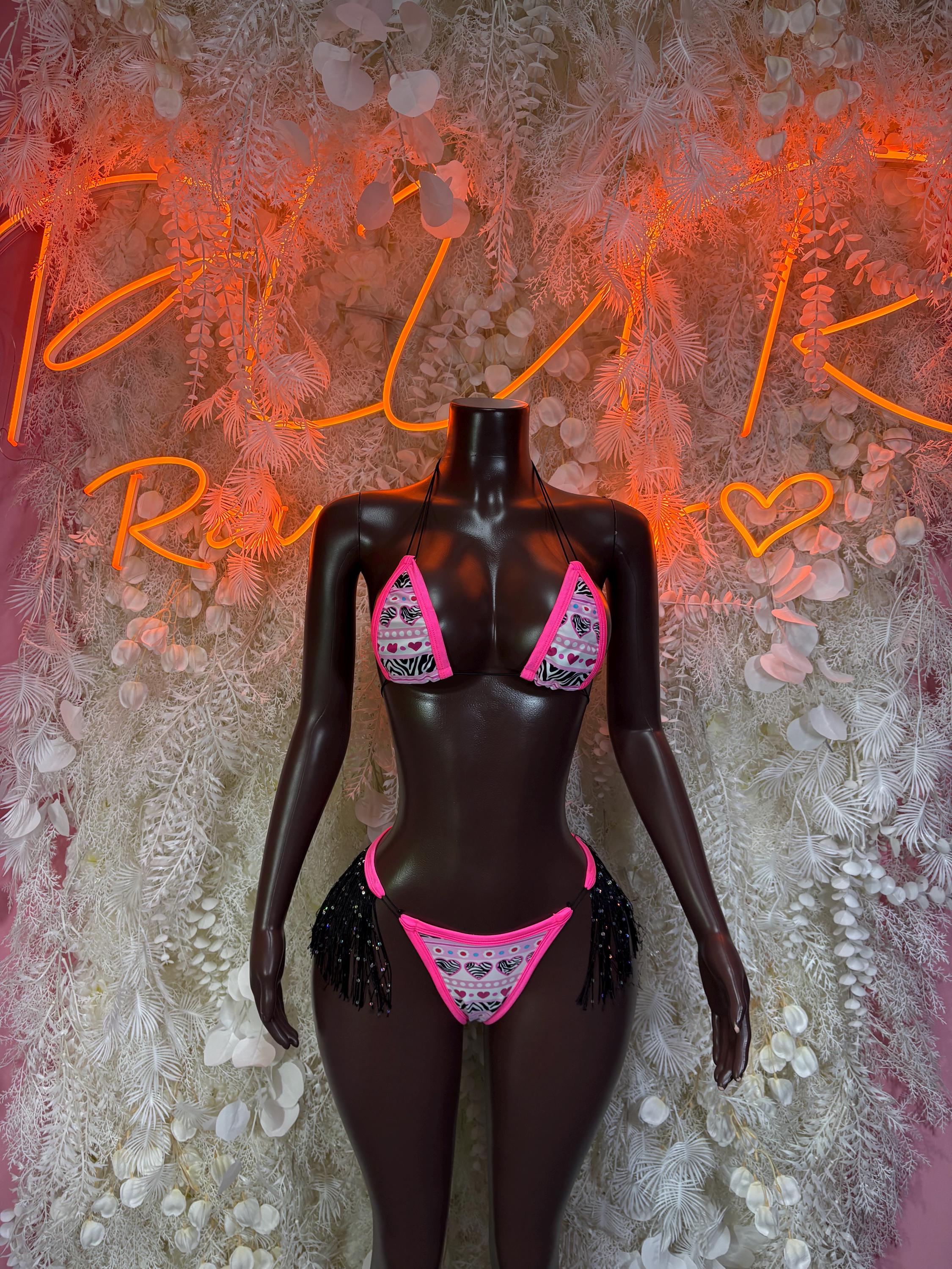 Two-piece rave bikini costume with black base, pink trim, and glittery fringe